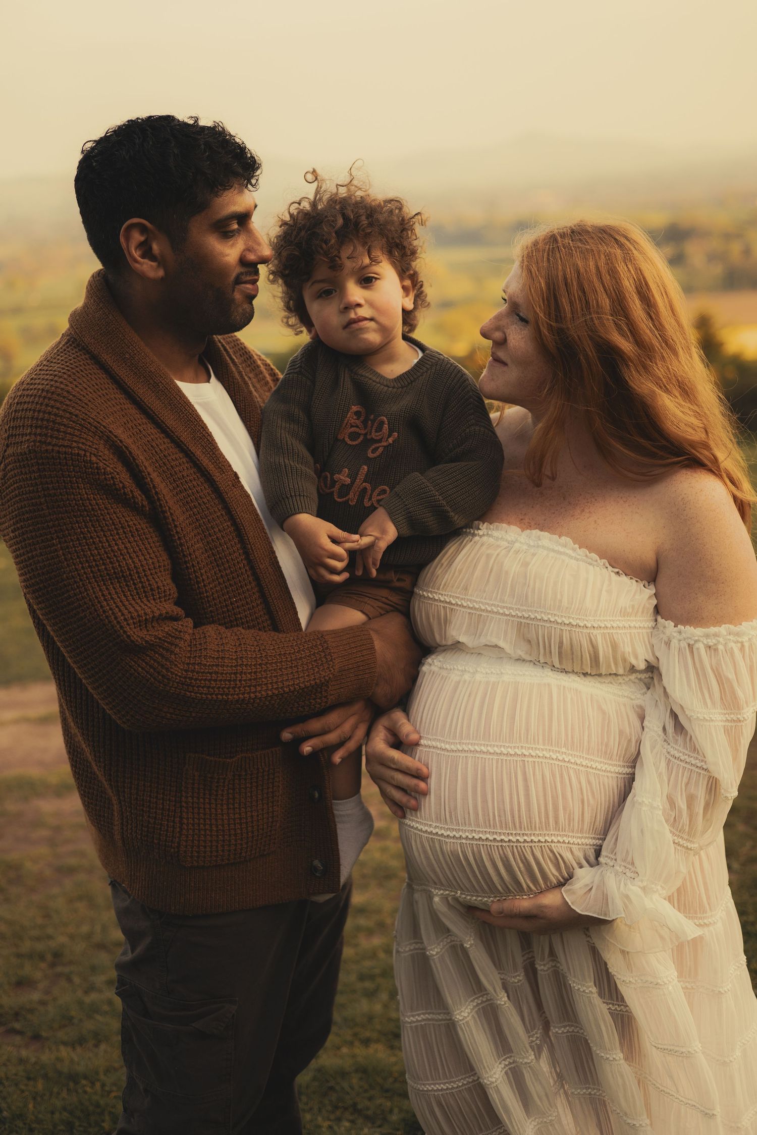 A family of three during a sunset photoshoot in Shrewsbury, Shropshire.