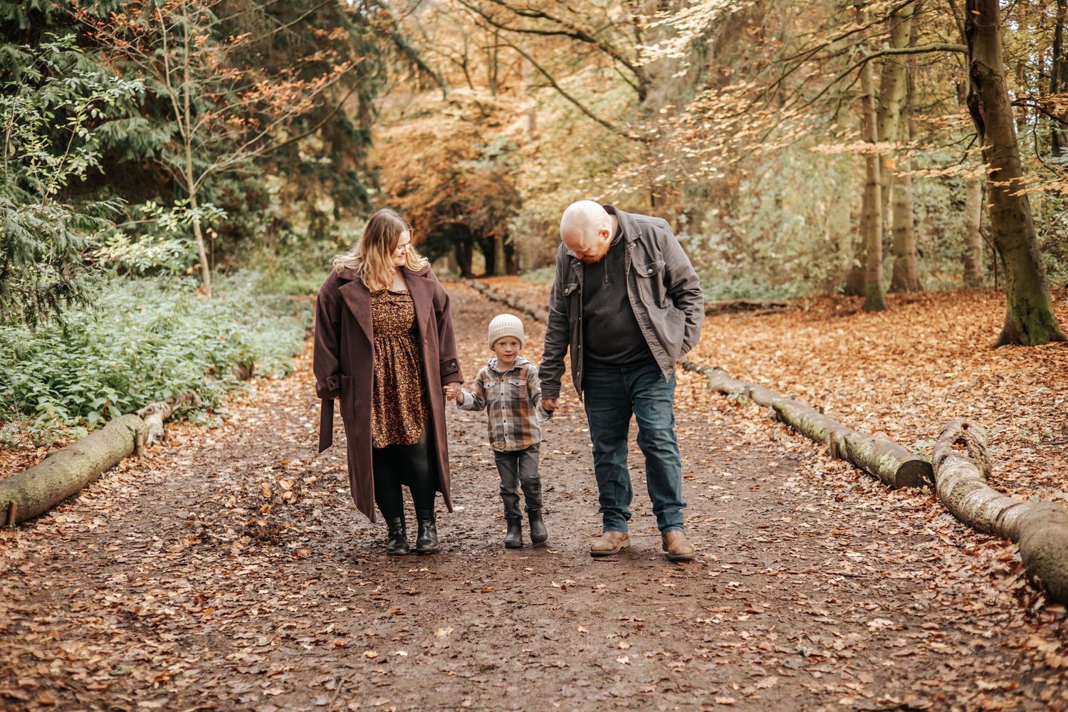 A mother, father and son during an Autumn photoshoot in Apley Woods, Telford, Shropshire.