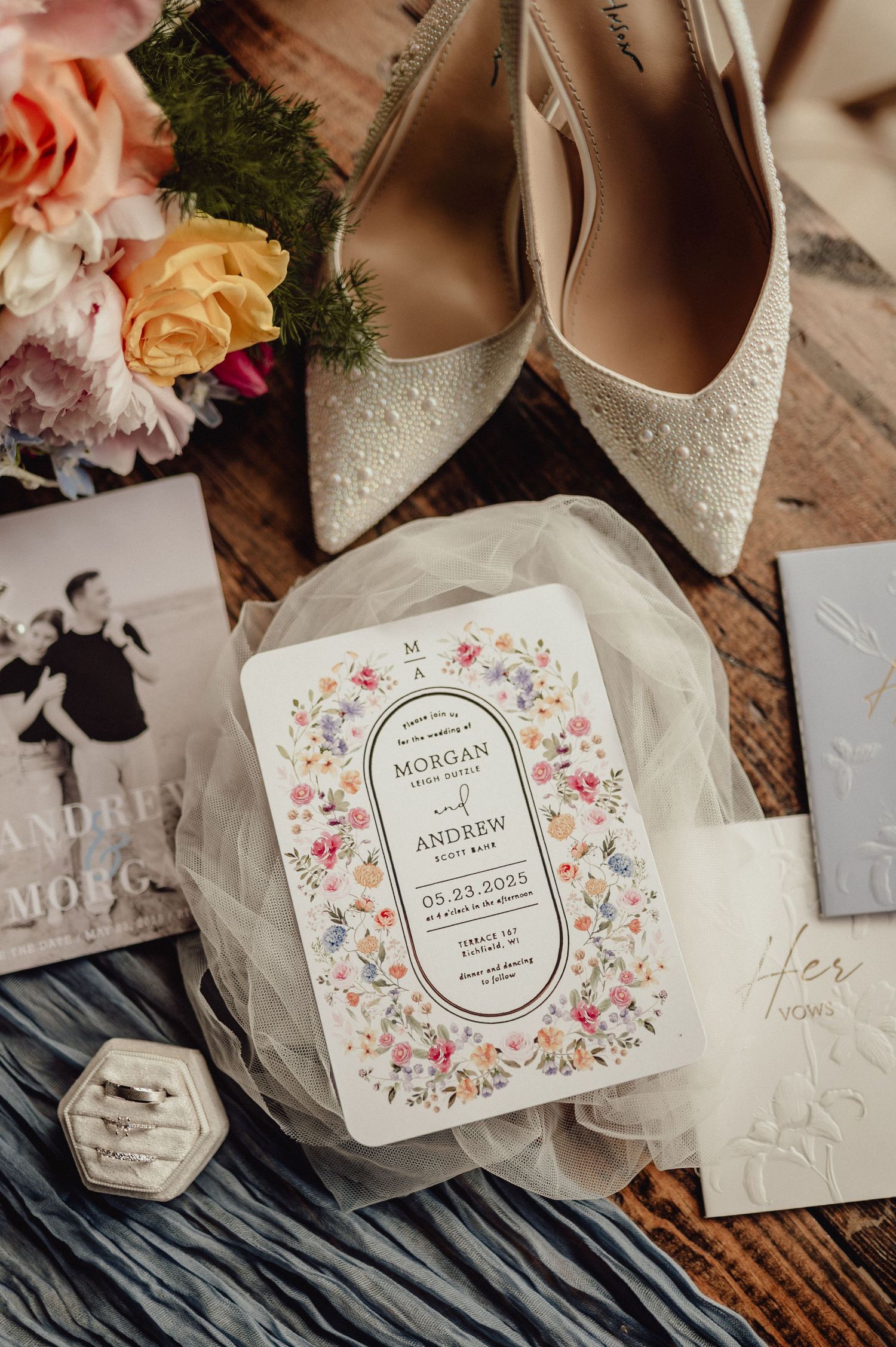 Wedding details featuring floral invitation suite, white shoes and delicate accessories.