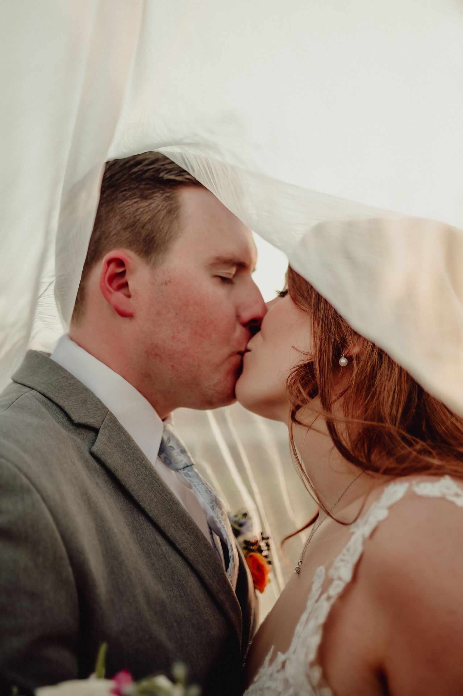 A romantic wedding kiss sequence showing multiple angles of the newlyweds sharing their first kiss as husband and wife.