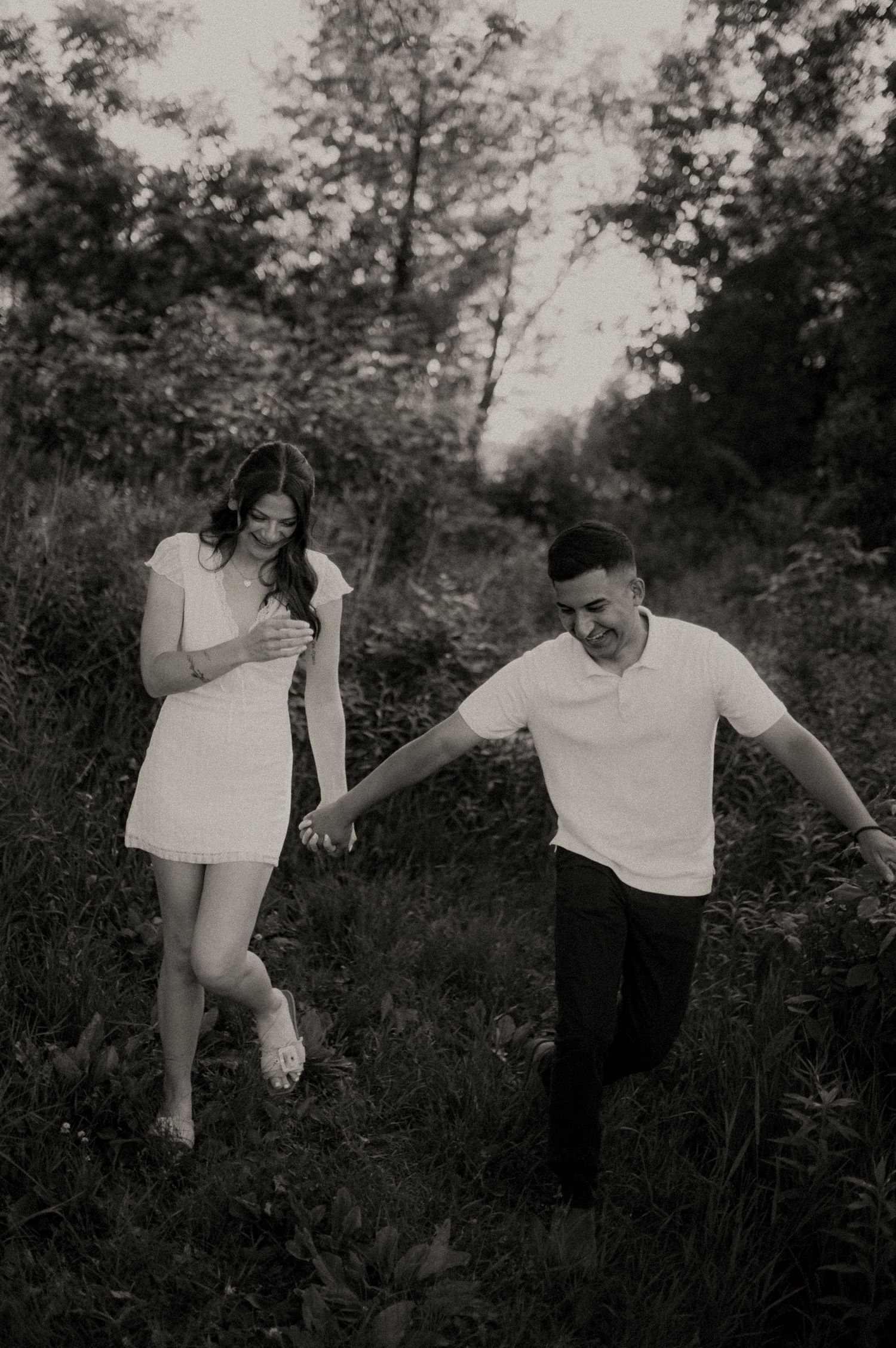 Playful black and white portrait session in natural outdoor setting.