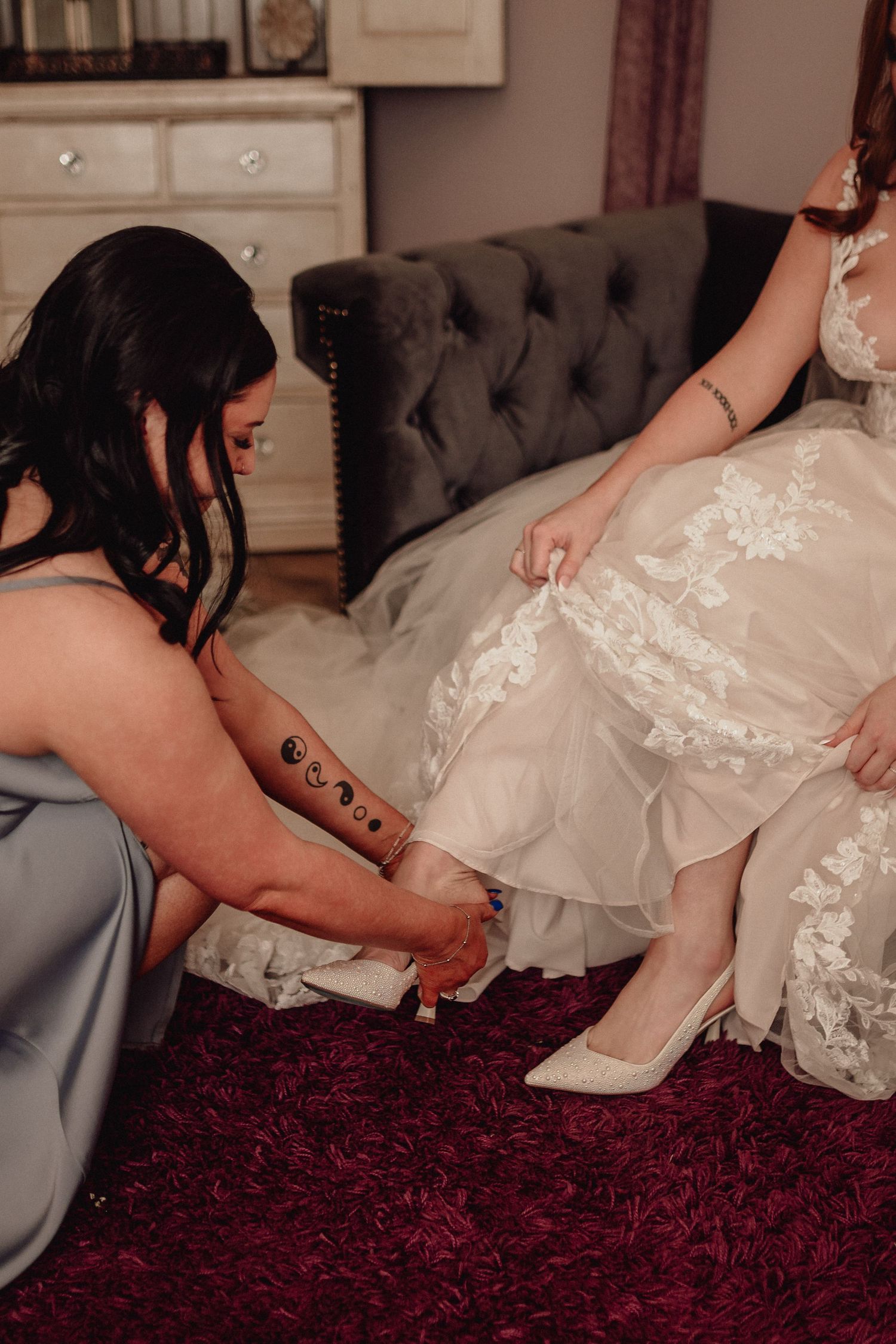 A sequence of photos showing someone helping a bride put on her wedding shoes on a burgundy carpet.
