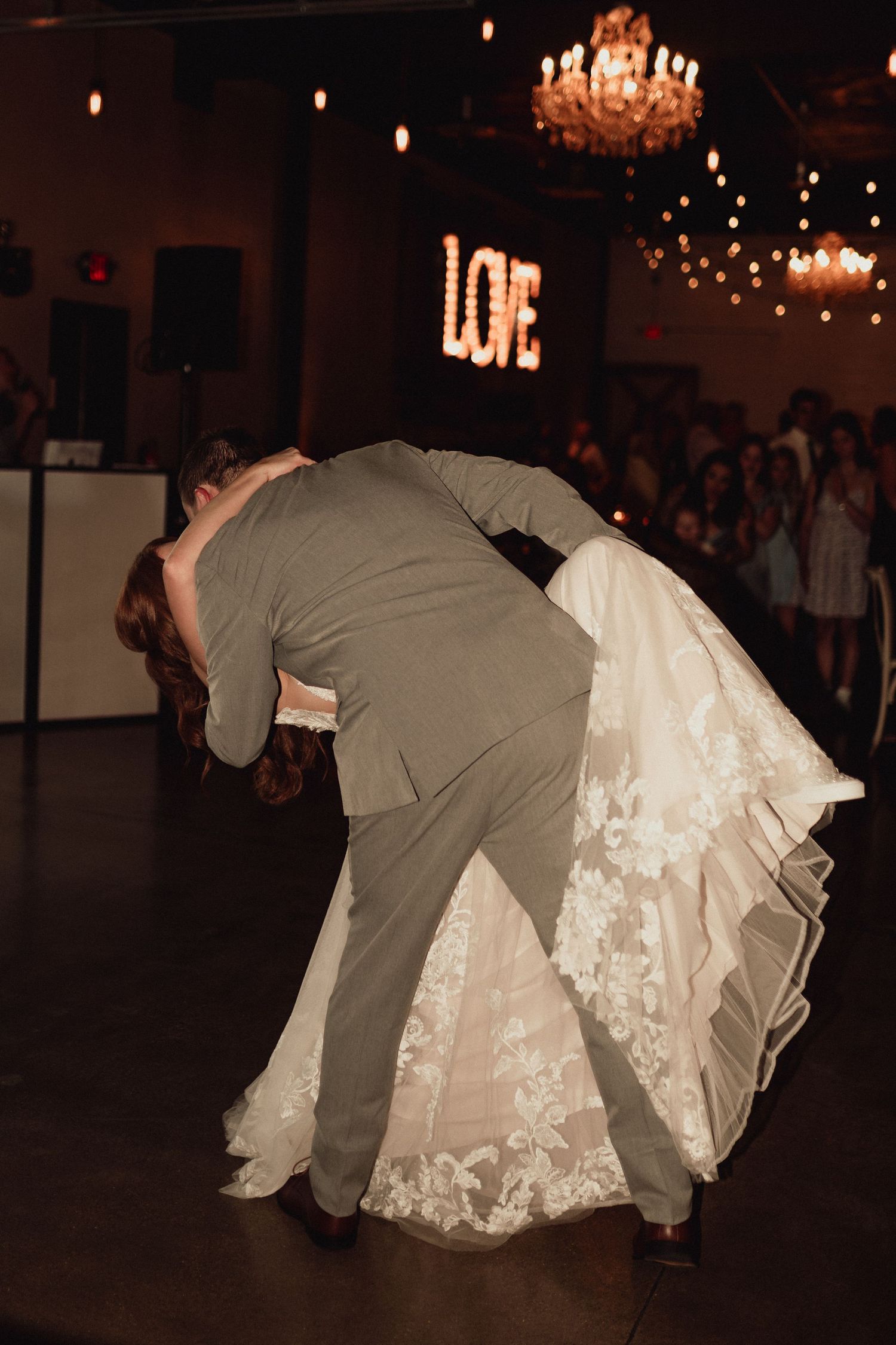A sequence of photos showing a couple performing a romantic dip dance move under warm lighting at a wedding reception.