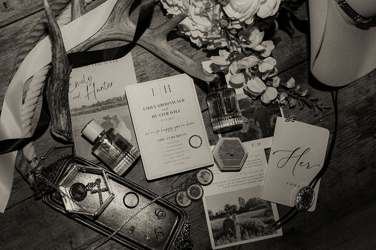 Wedding stationery and details arranged in a black and white flatlay composition.