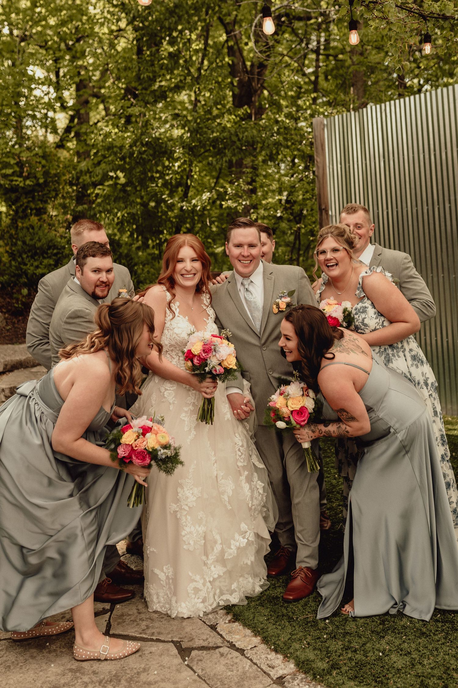 Wedding party in gray and white attire poses playfully in sequence of candid group shots outdoors.