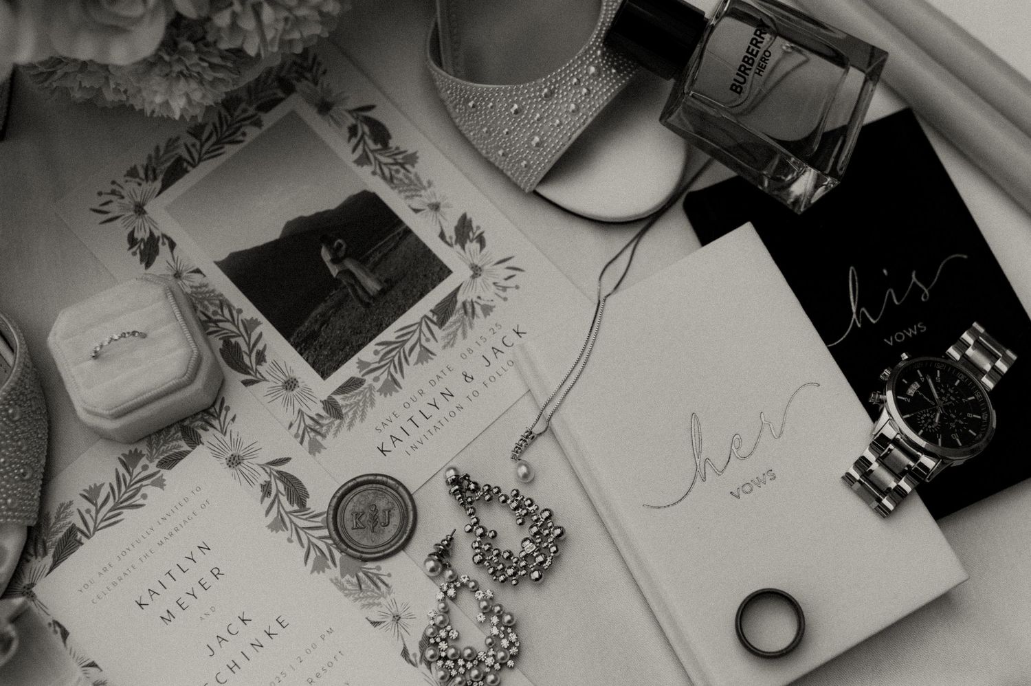 Wedding stationery and details arranged artistically in black and white.