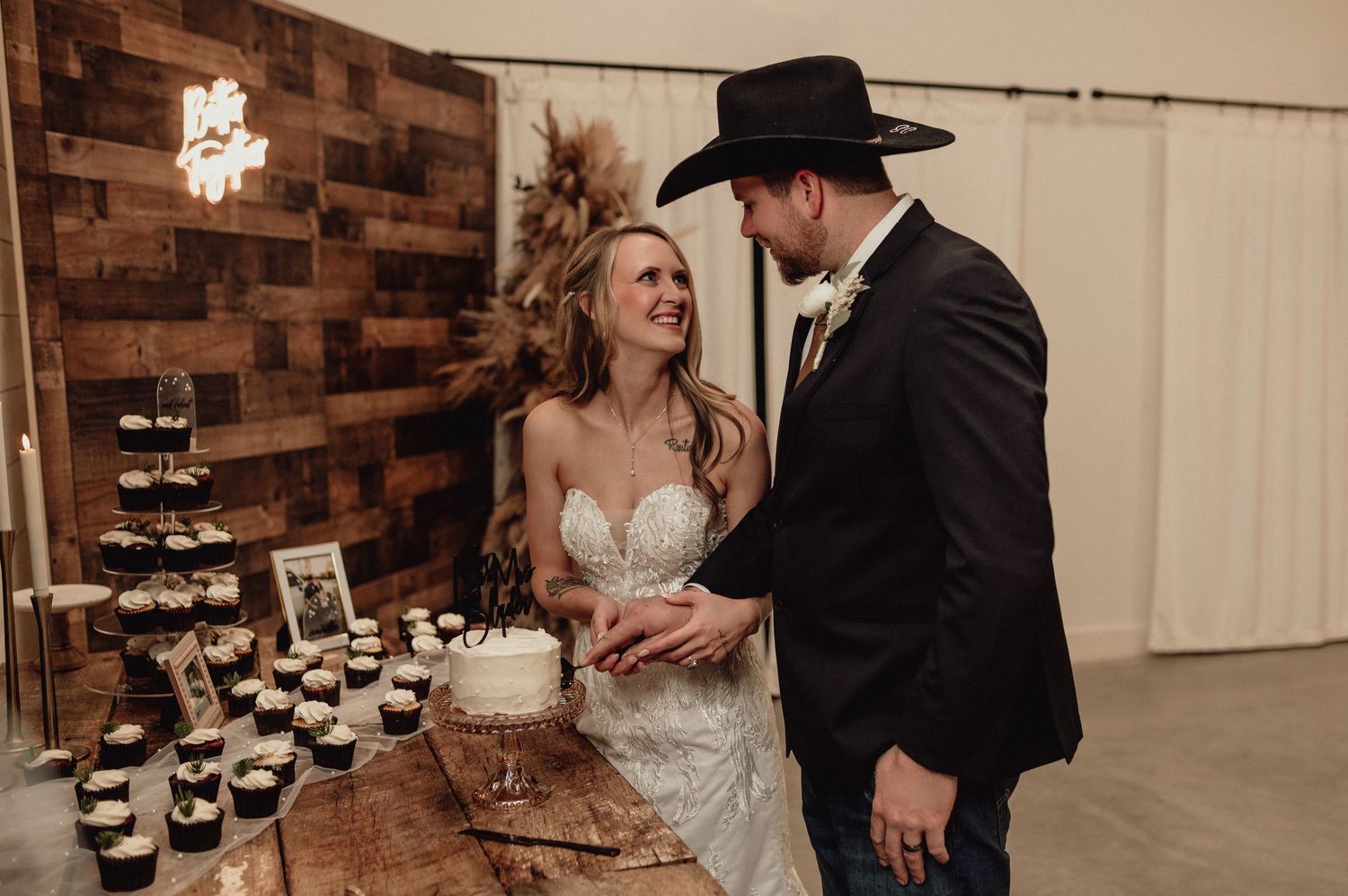 Collage of wedding reception moments with cake cutting and dancing in a rustic brick-walled venue.