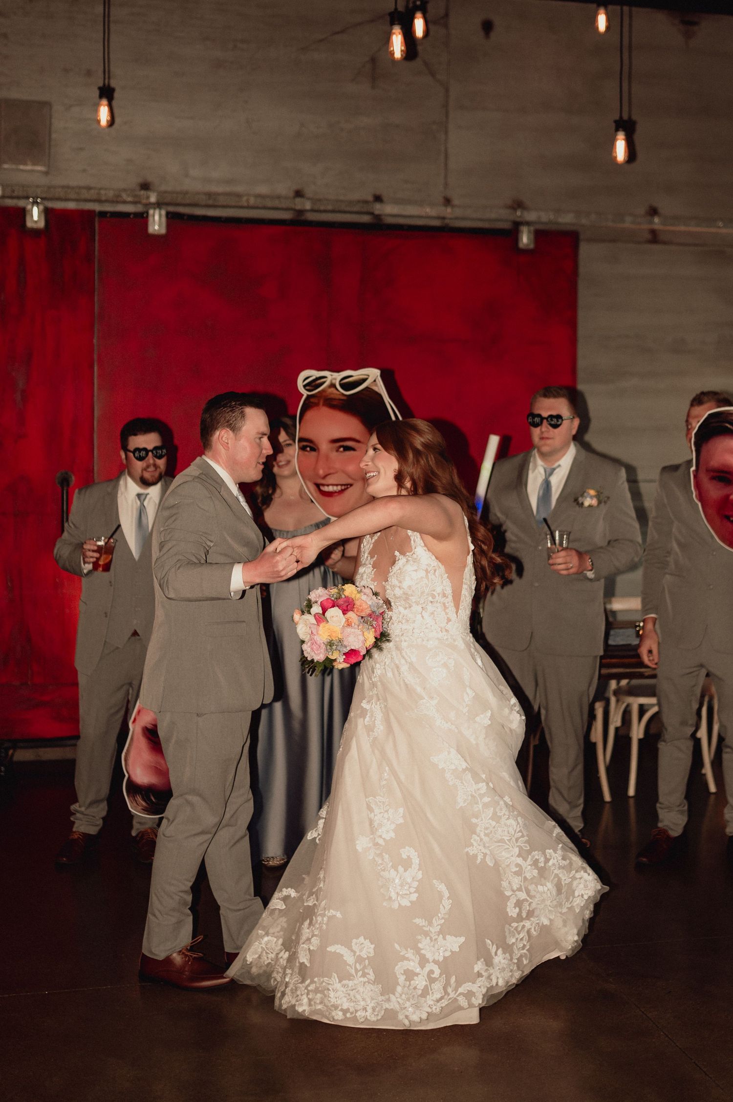 A romantic wedding dance sequence showing a couple in gray suits and white dress spinning across a dark venue floor.