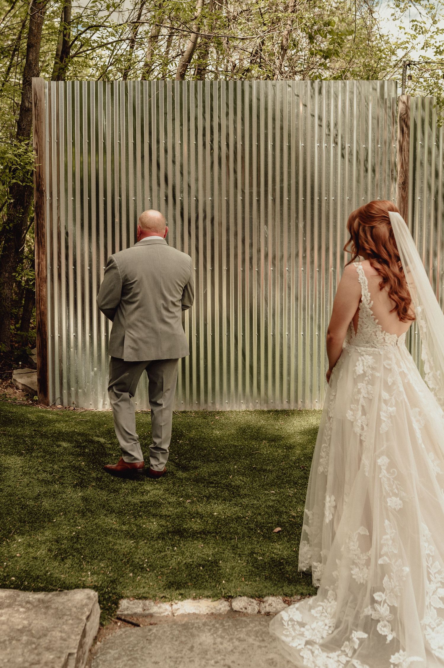 A series of wedding photos showing a bride and groom peeking through a corrugated metal fence in an outdoor garden setting.