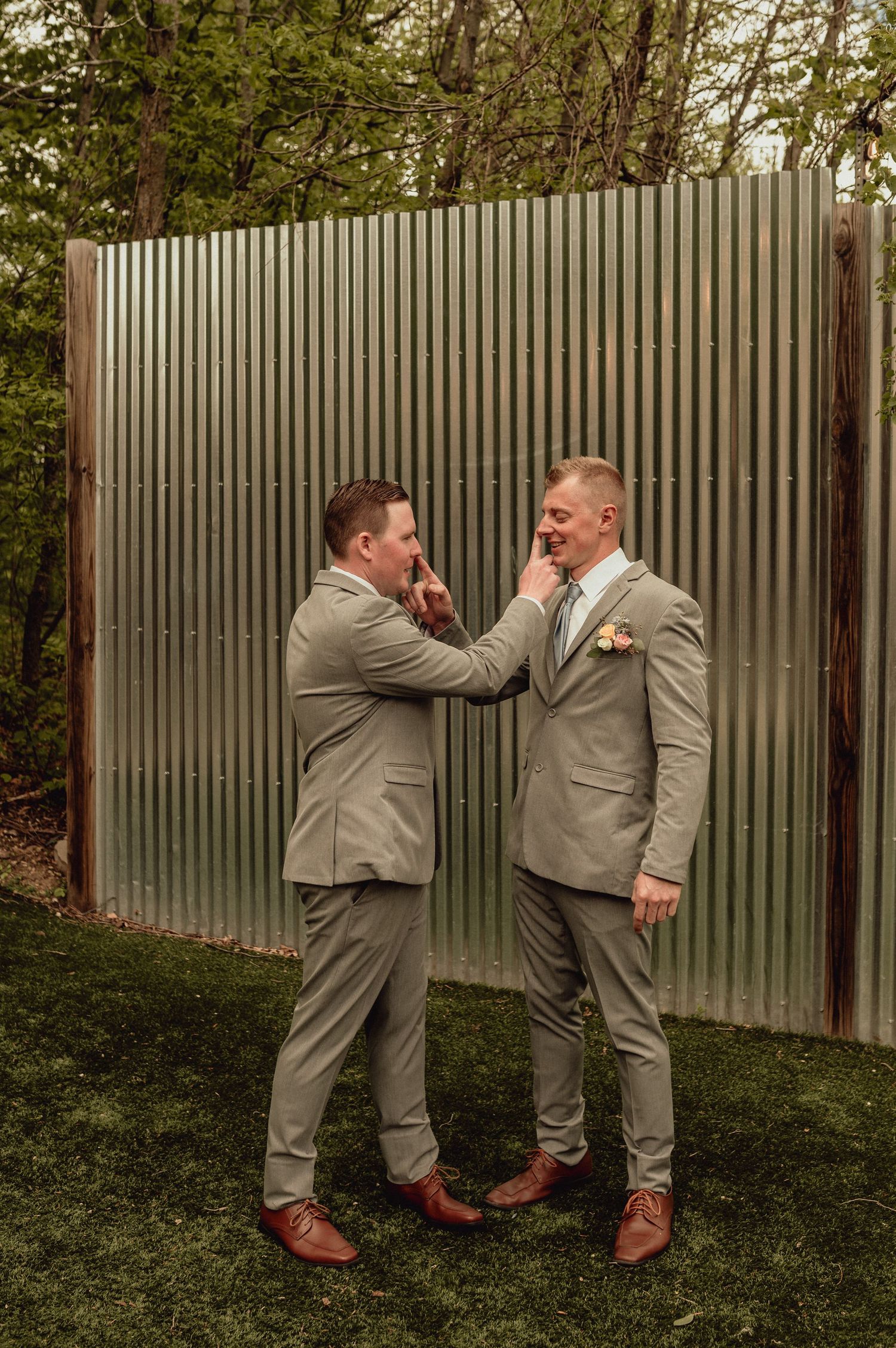 A sequence of five photos showing two people in beige suits playfully interacting against a corrugated metal wall outdoors.
