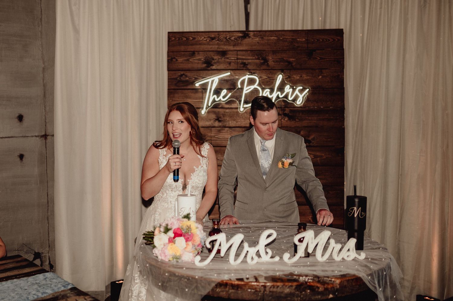 Wedding reception collage showing cake cutting, first dance, and decor details in a rustic venue with wooden accents.