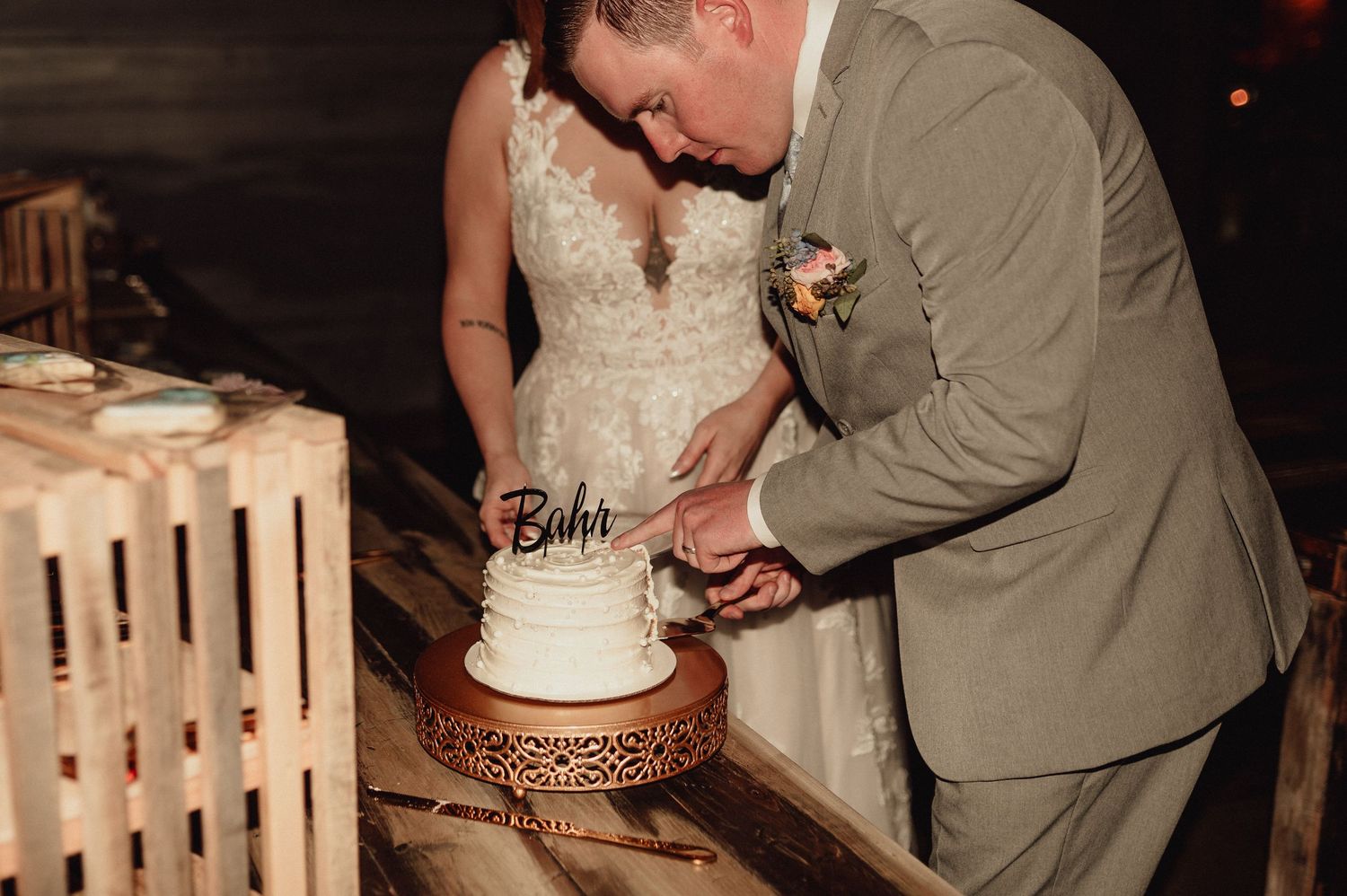 A wedding couple cuts their white tiered cake together in a sequence of photos showing the traditional cake cutting moment.