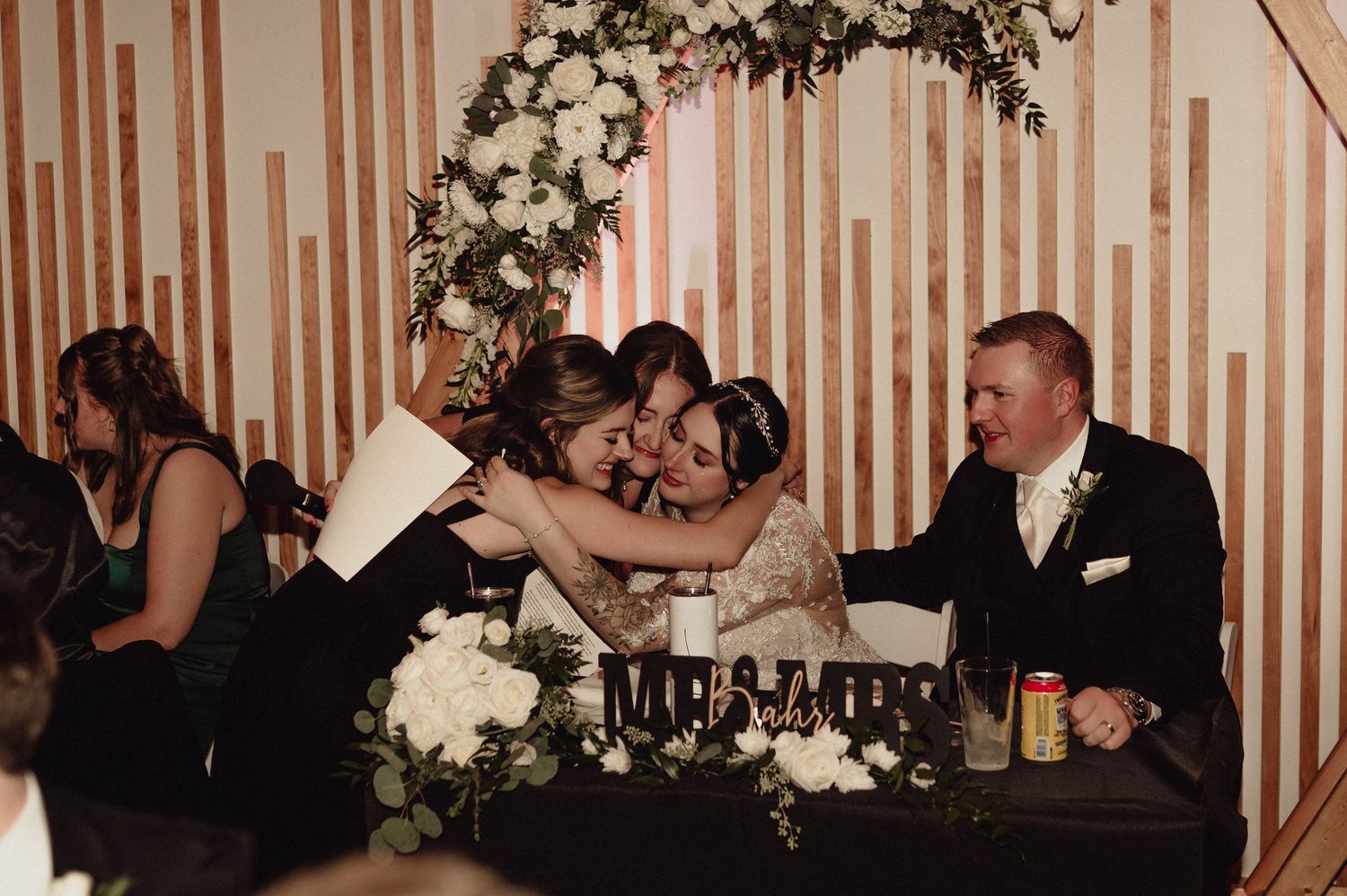 A collage of black and white wedding reception photos showing dancing, embraces and celebrations at an elegant venue.