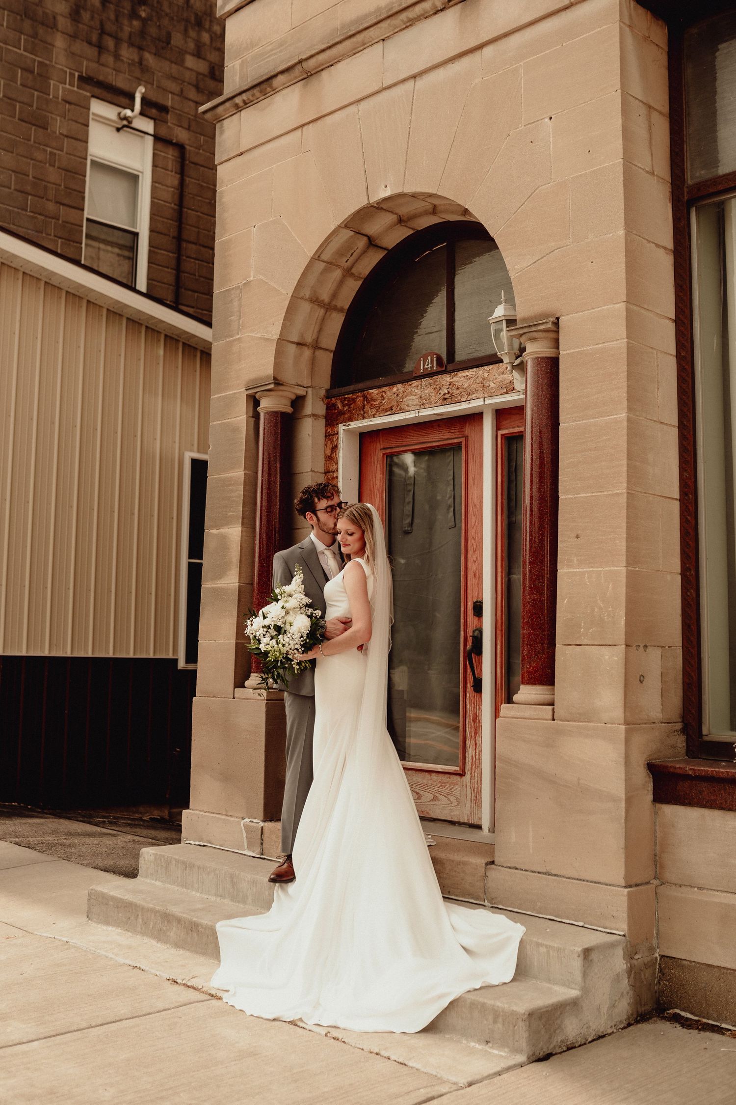 Classic brick building exterior with arched windows and white architectural details.