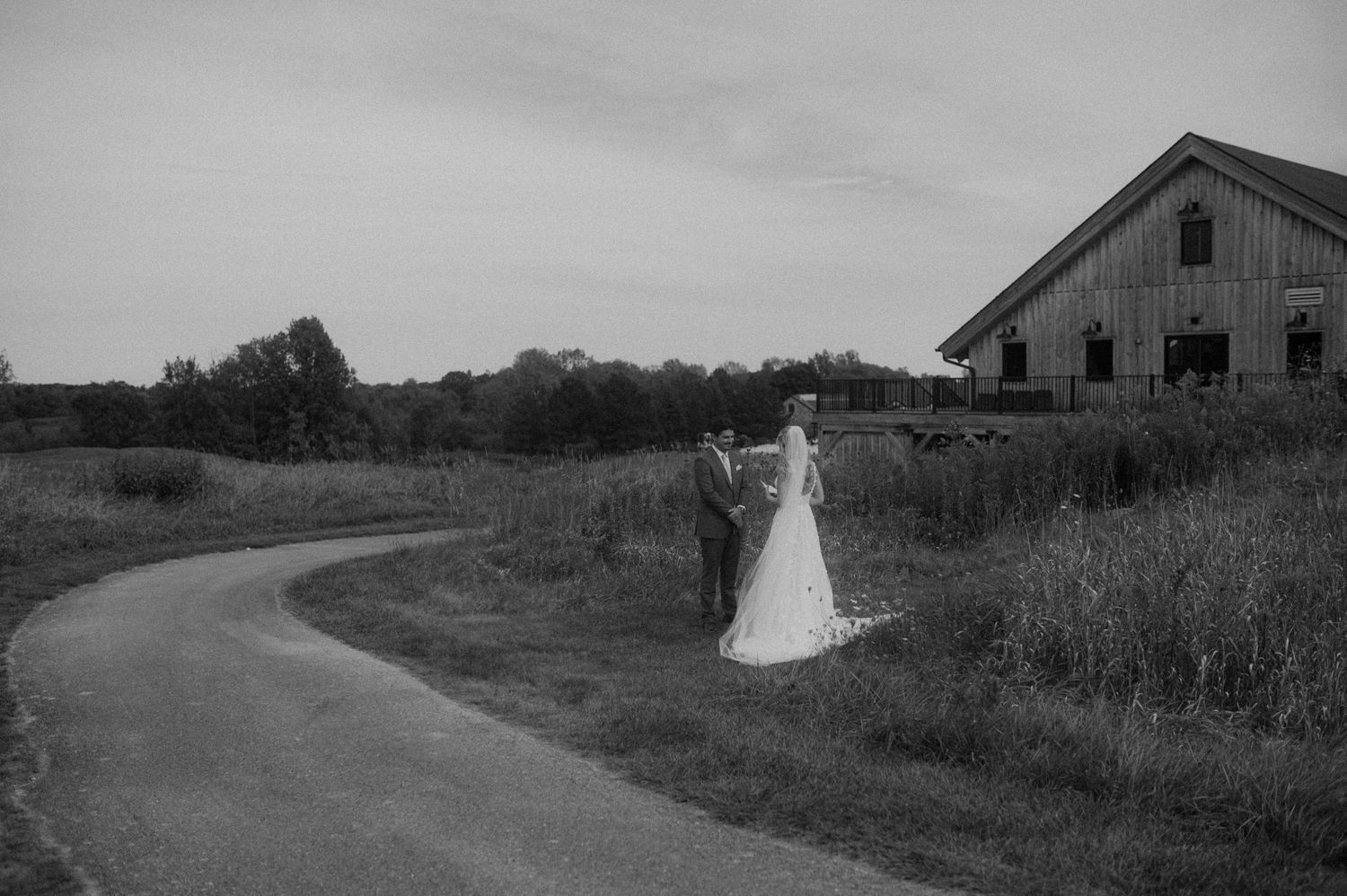 A series of black and white photographs showing rural country roads winding through farmland with barns in the distance.
