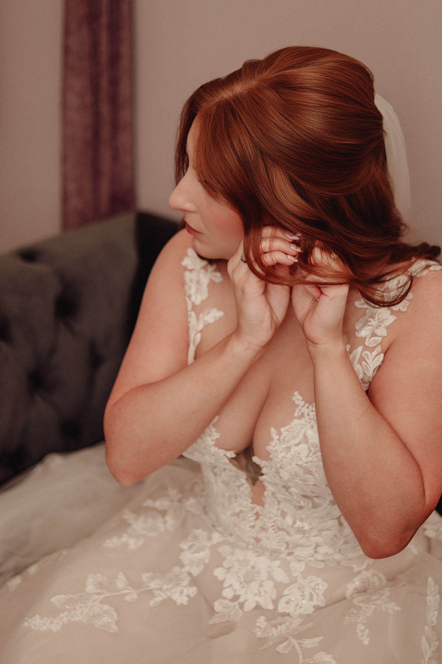 Close-up view of intricate white lace floral details on the back of a wedding dress.