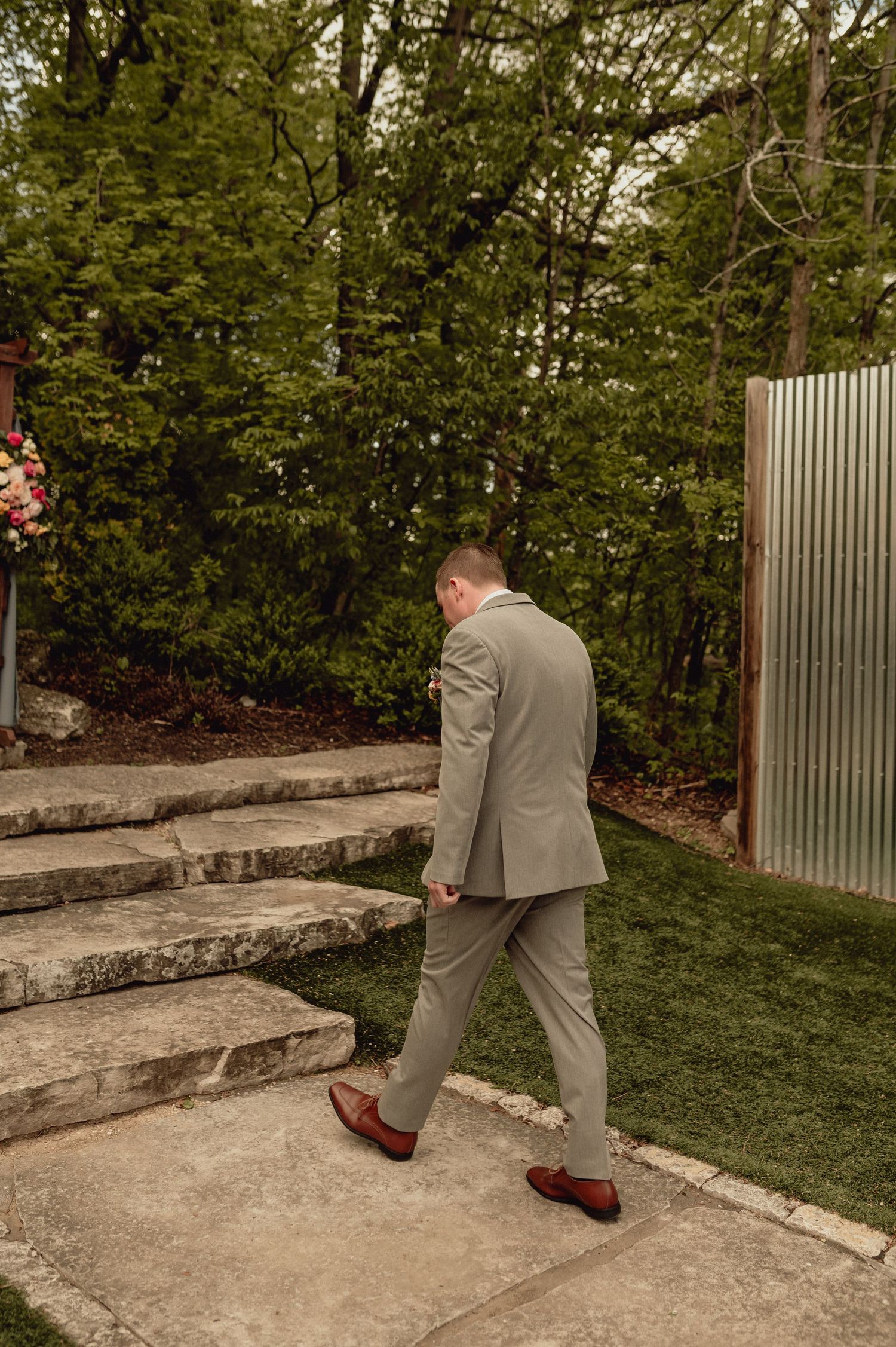 A person in a gray suit demonstrates how to safely walk down concrete garden steps in a sequence of photos.