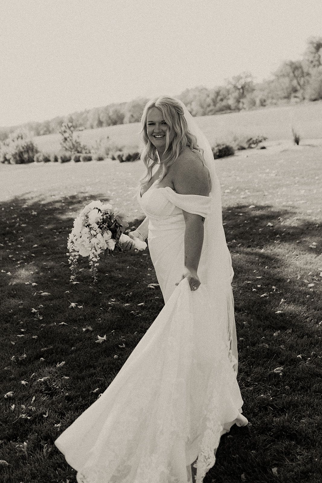 Artistic sequence of a bride in a flowing white dress twirling in a sunlit field.