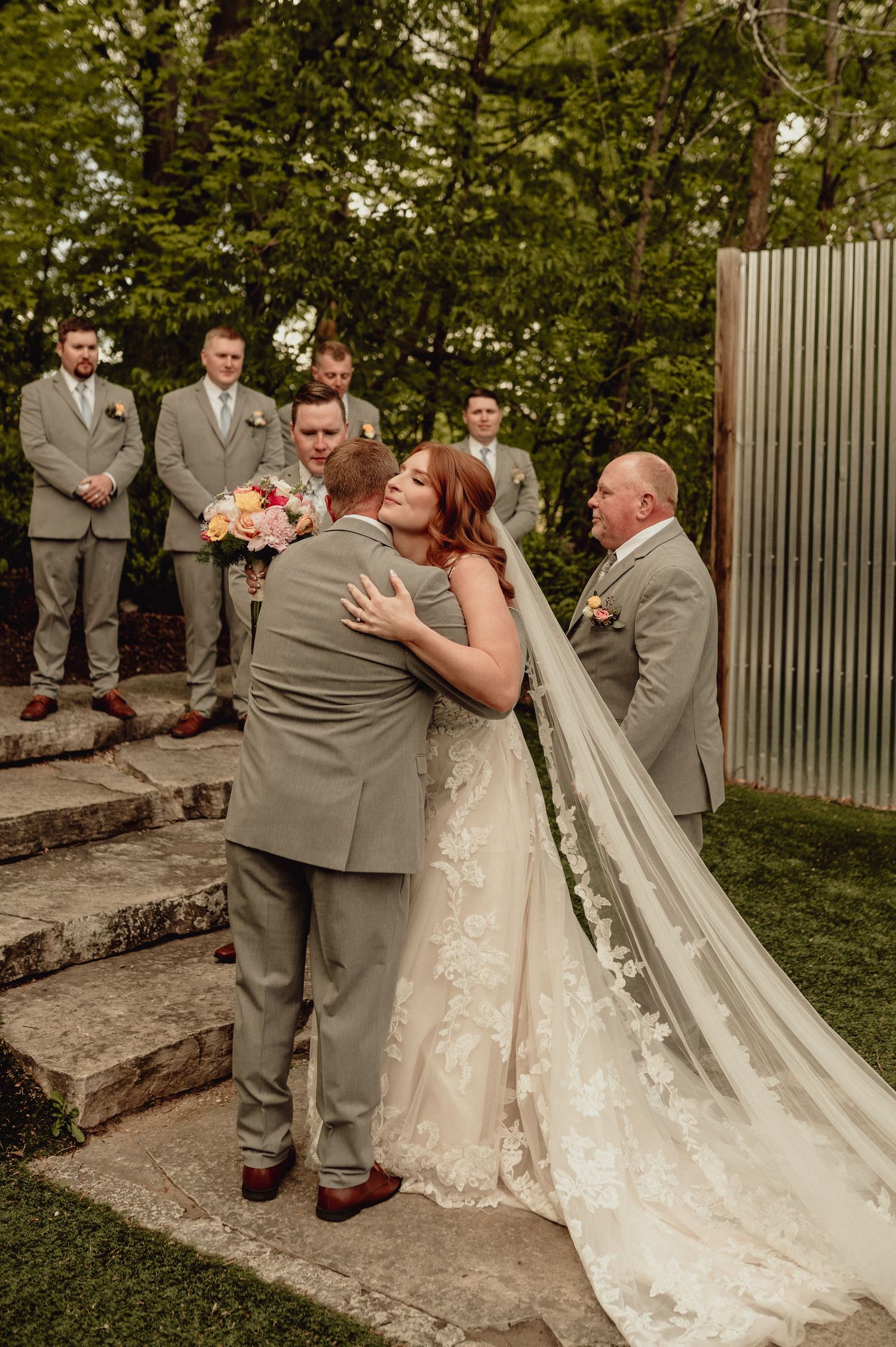 A series of wedding ceremony photos showing a bride in a lace dress and groom in gray suit sharing intimate moments outdoors.