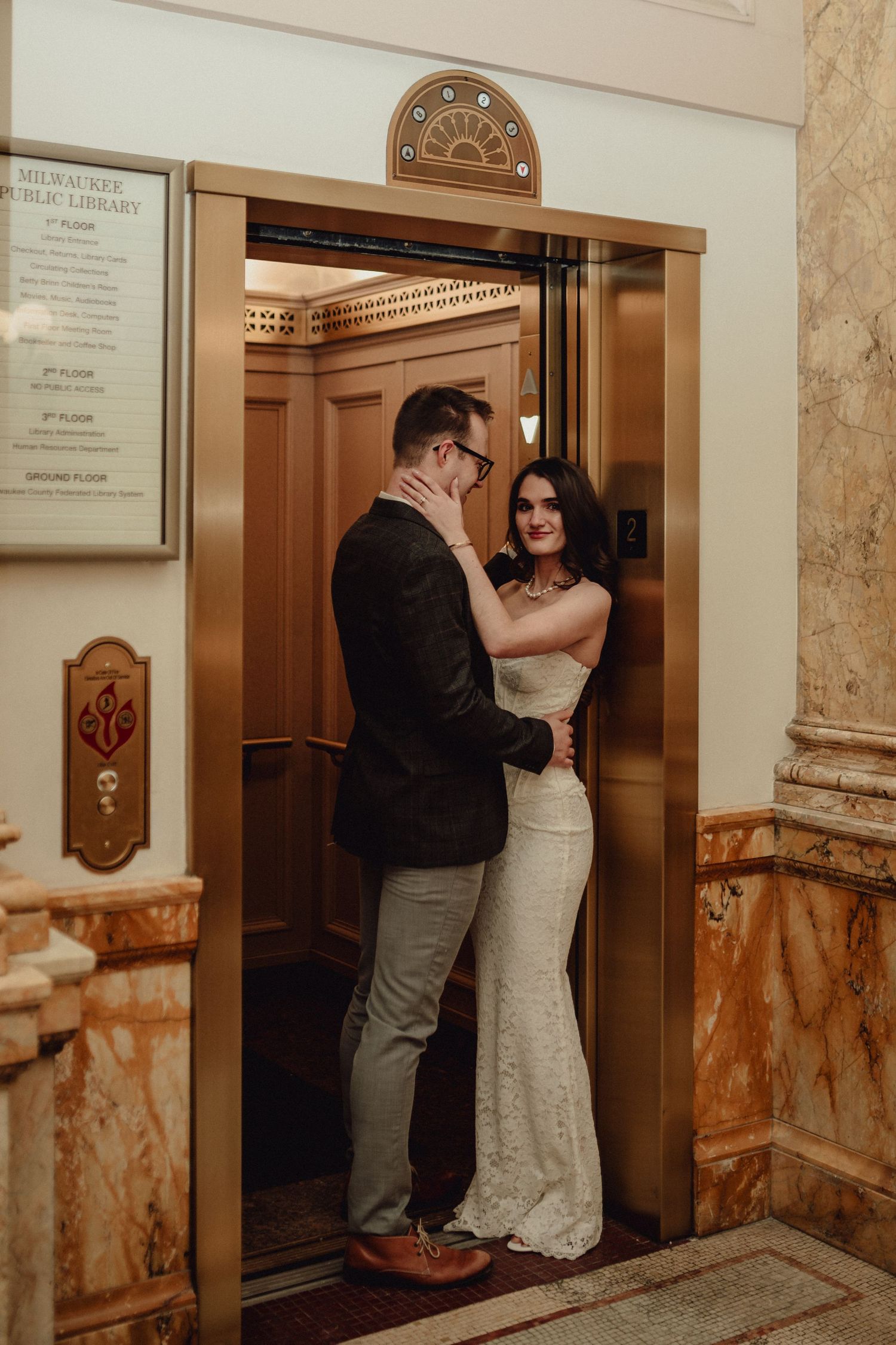 A series of four vintage elevator photos showing a couple in wedding attire entering and embracing in an ornate marble hallway.