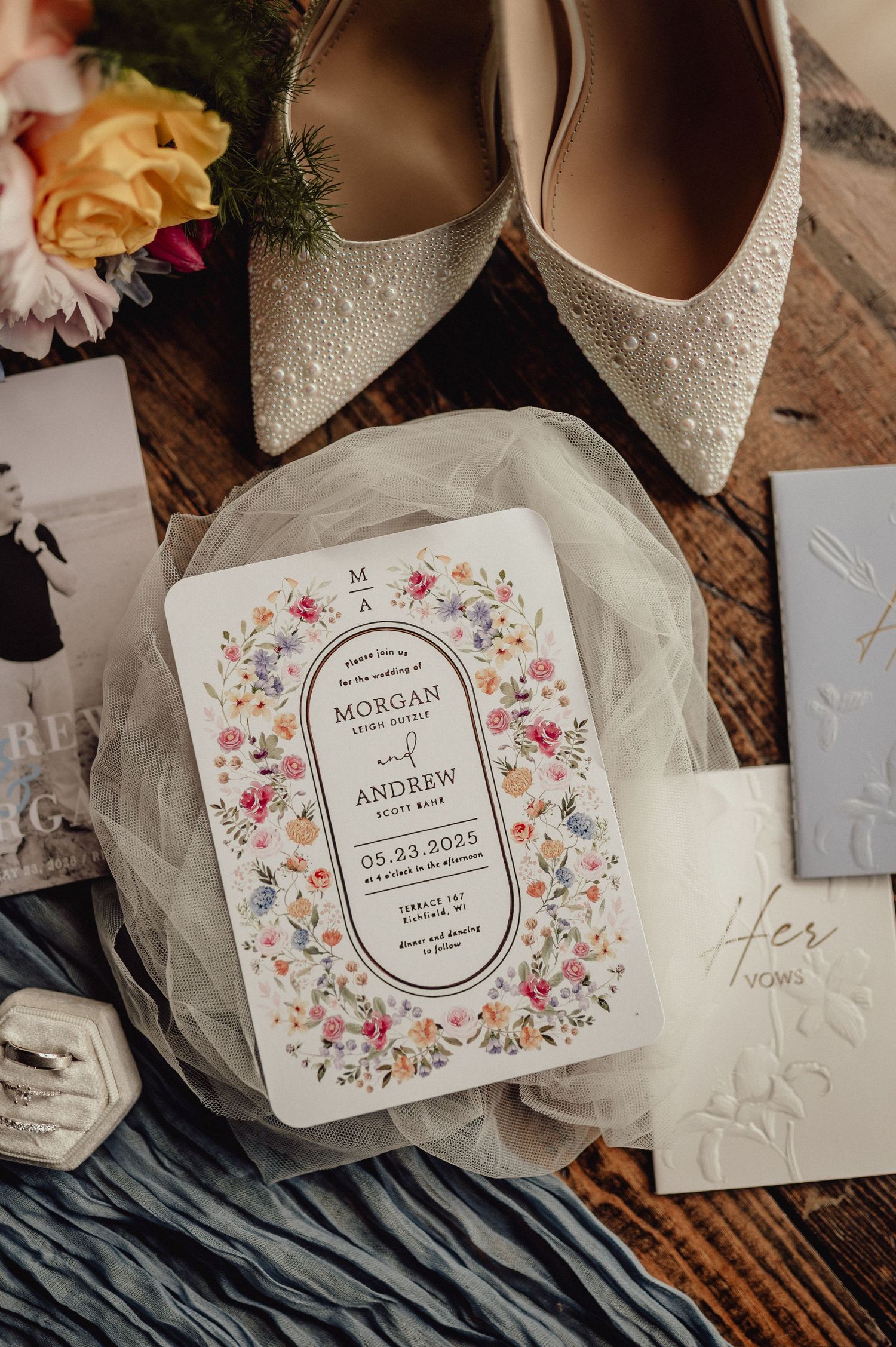 Elegant wedding invitation suite with floral designs and calligraphy on cream paper with delicate details.
