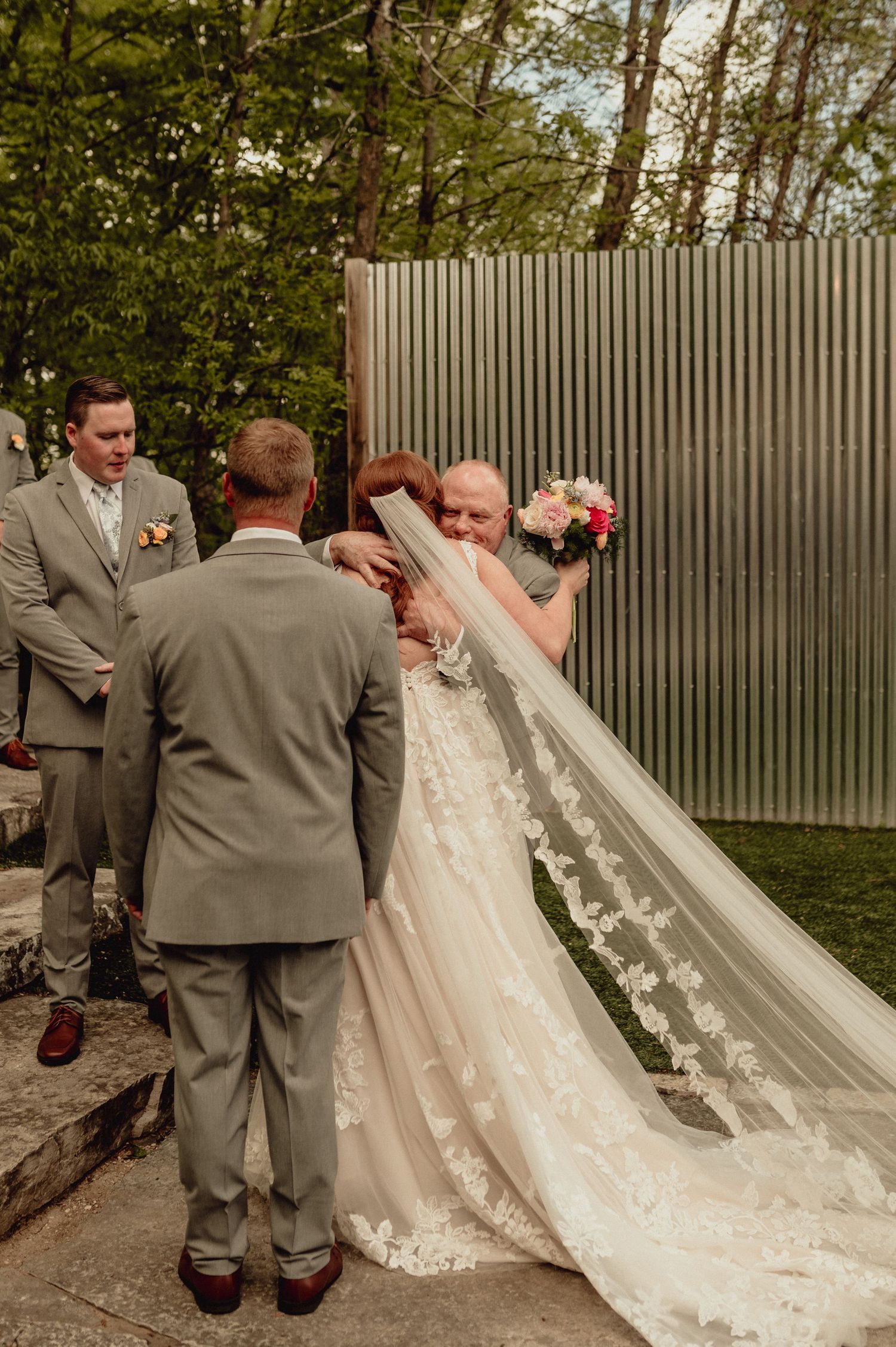A romantic wedding sequence showing a couple in gray suits and white dress sharing intimate moments in an outdoor setting.