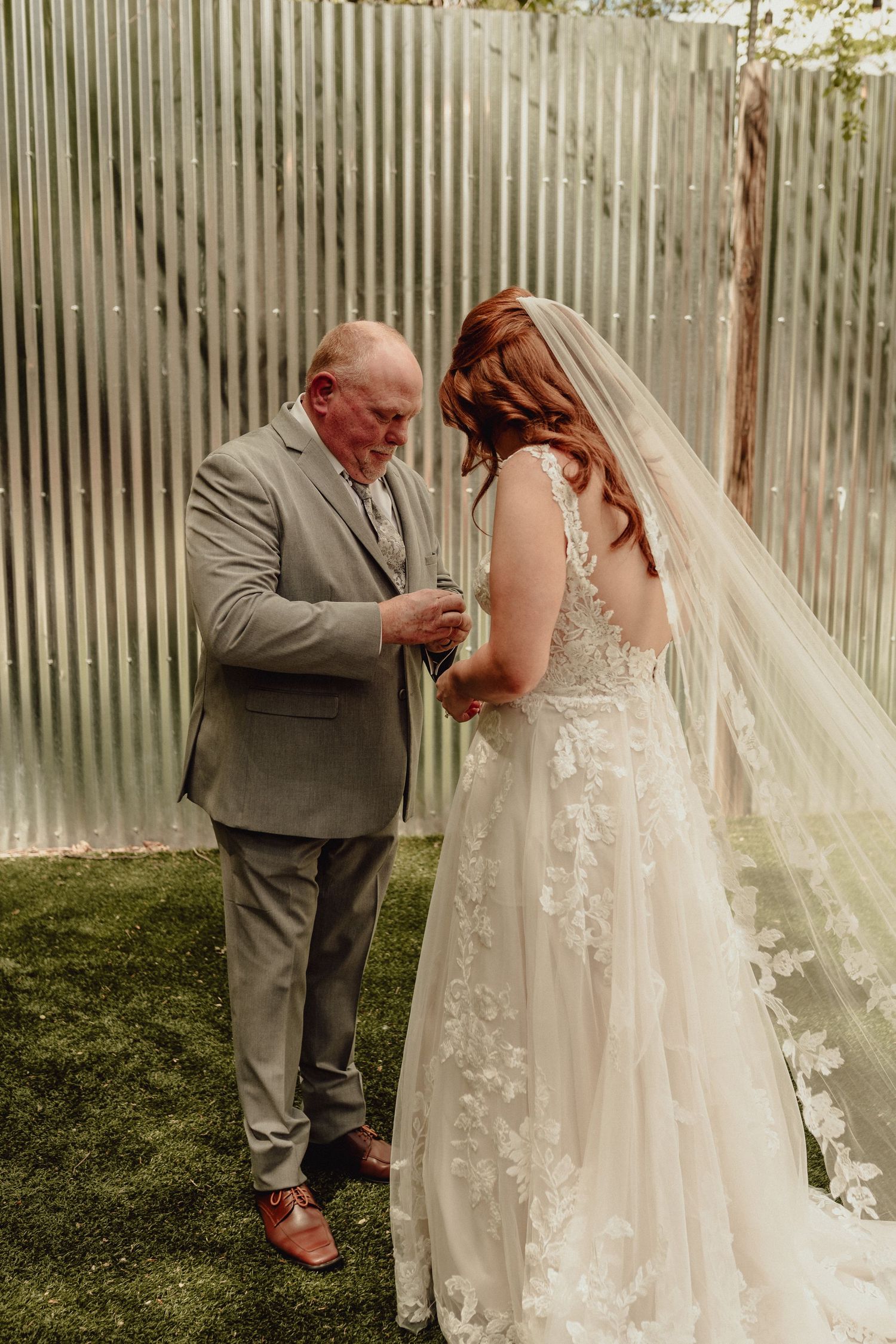 A tender moment captured in a series of photos showing a couple in wedding attire embracing outdoors against a rustic backdrop.