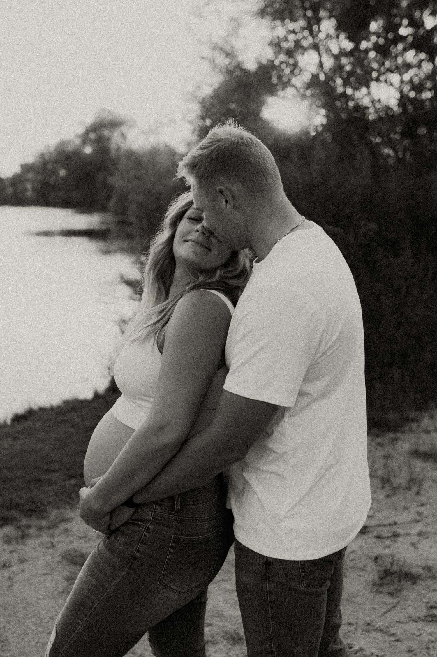 Black and white photos capturing romantic moments between a couple on a beach.