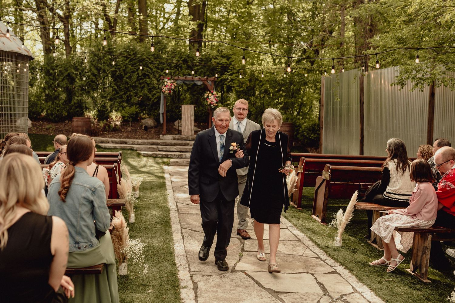 A series of candid outdoor wedding photos showing guests mingling and celebrating in a garden setting.