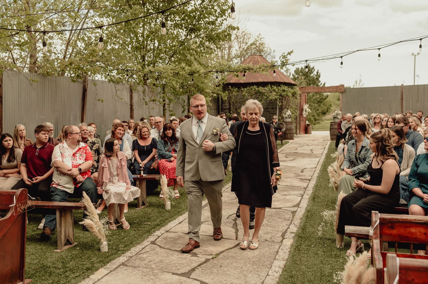 A collage of outdoor wedding reception scenes with string lights, dancing guests and rustic decor in a garden setting.