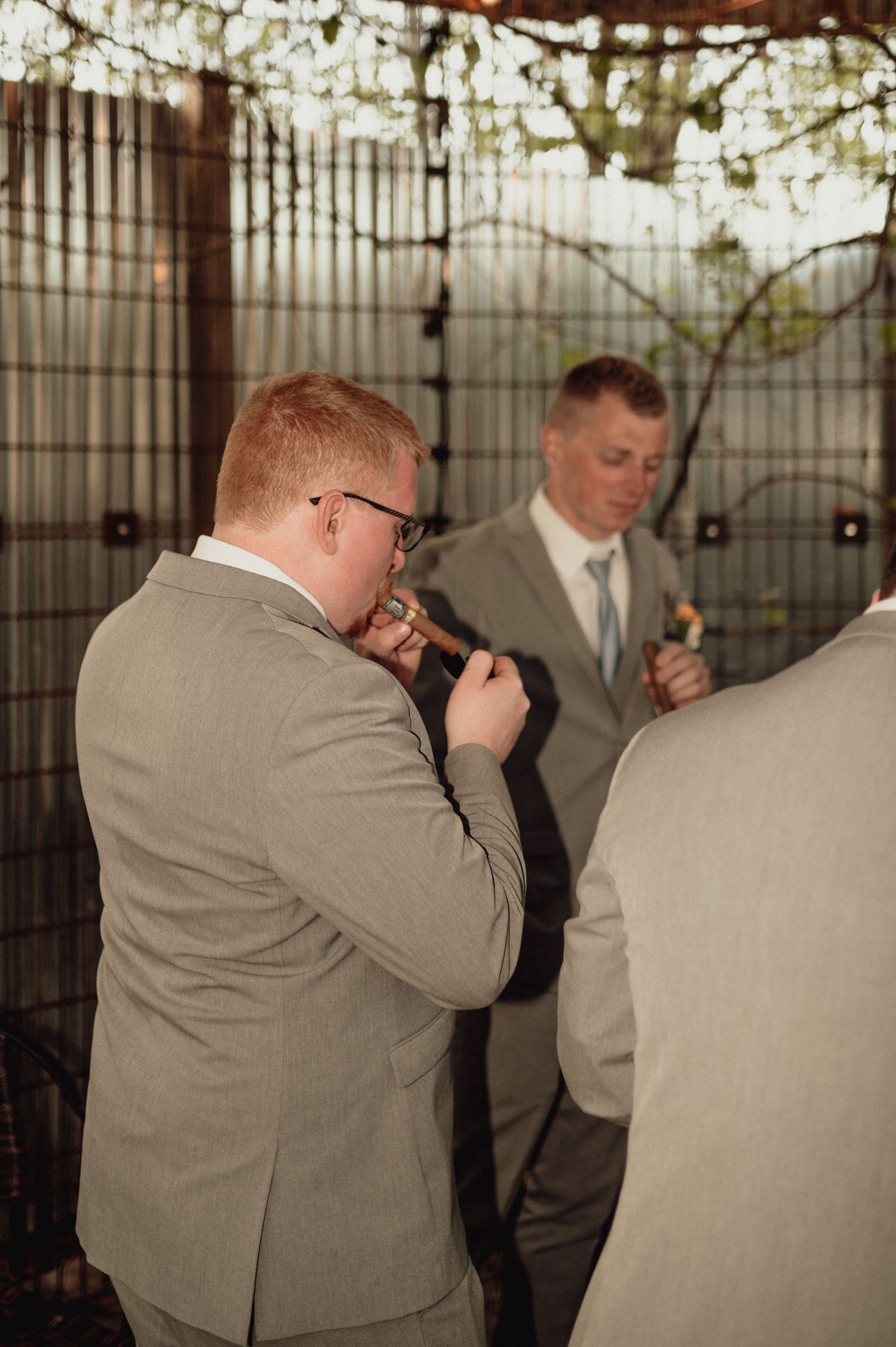 A sequence of photos showing a photographer in a gray suit taking pictures in an indoor venue with string lights.