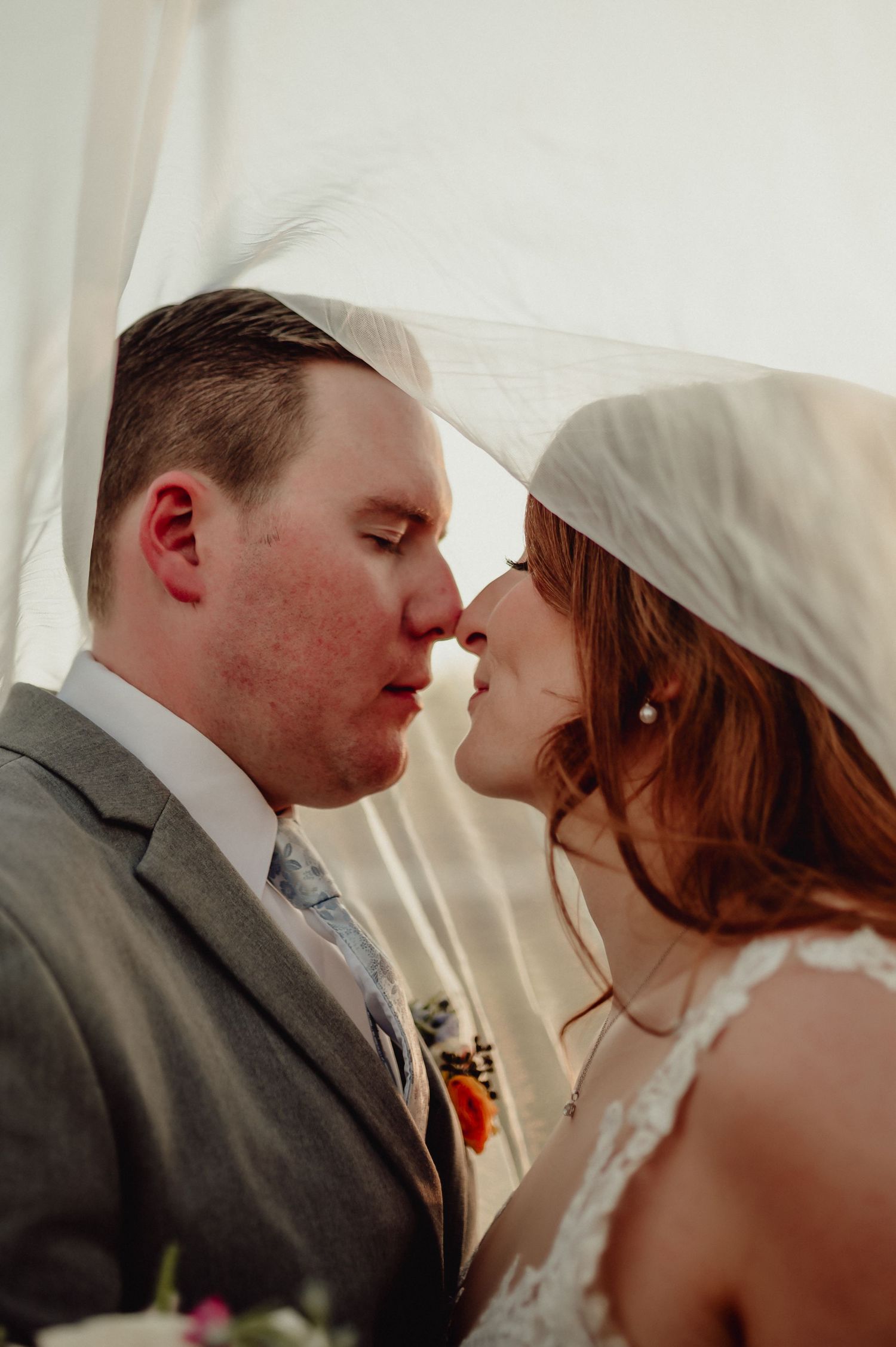 A series of candid wedding photos capturing an intimate kiss between bride and groom in soft natural lighting.