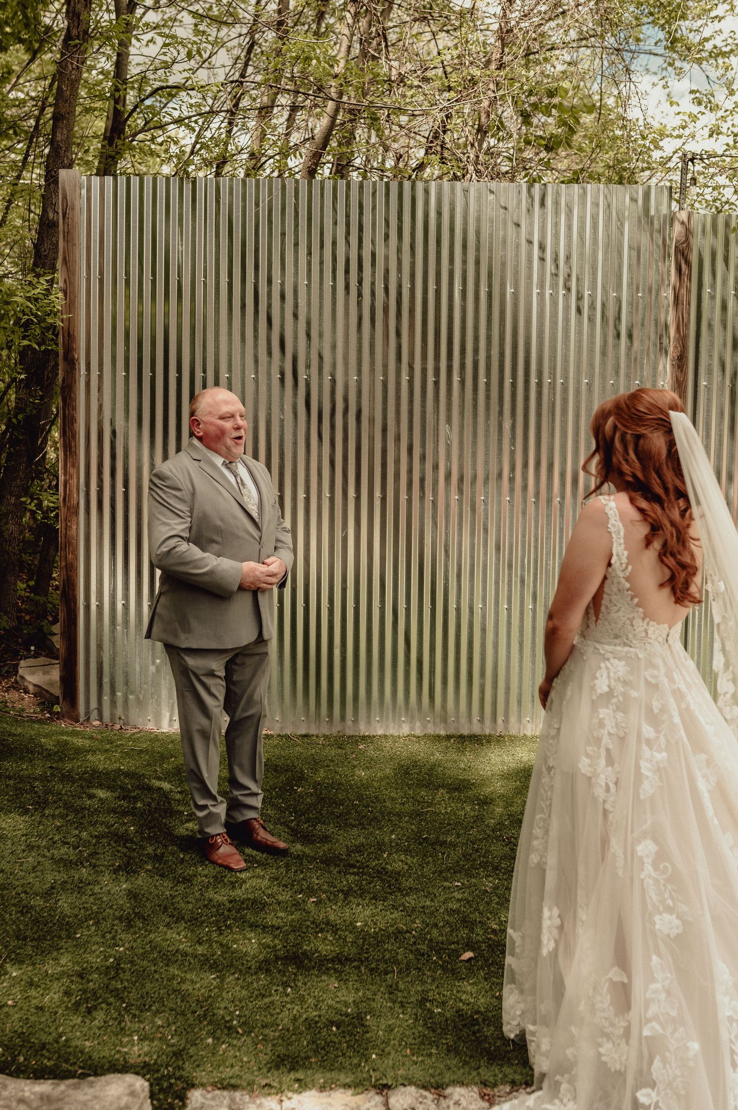A first look wedding moment captured in a sequence showing a couple's emotional reaction in a backyard garden setting.