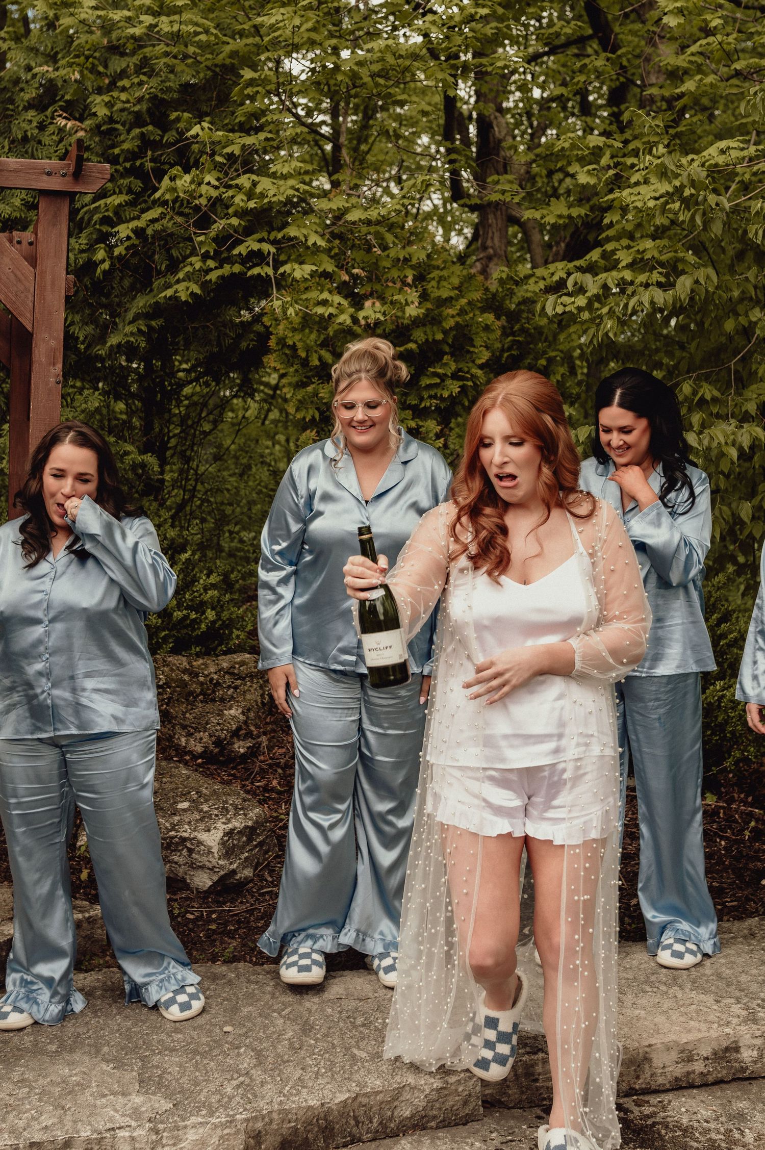 A sequence of candid wedding party photos showing people in silver satin outfits and white lace reacting with laughter and joy.