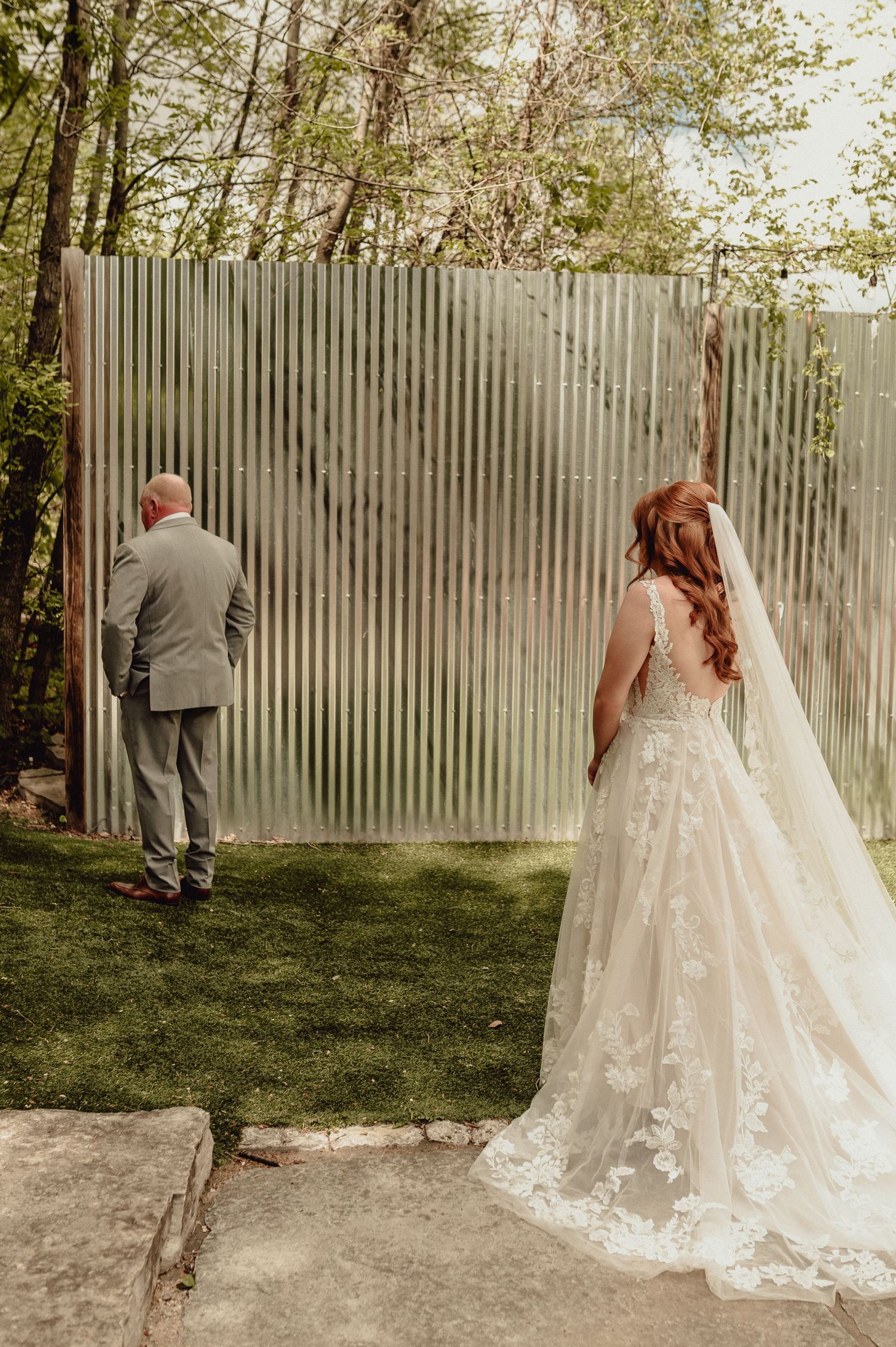 A series of wedding photos showing a couple in formal attire having a first look moment in a garden setting.