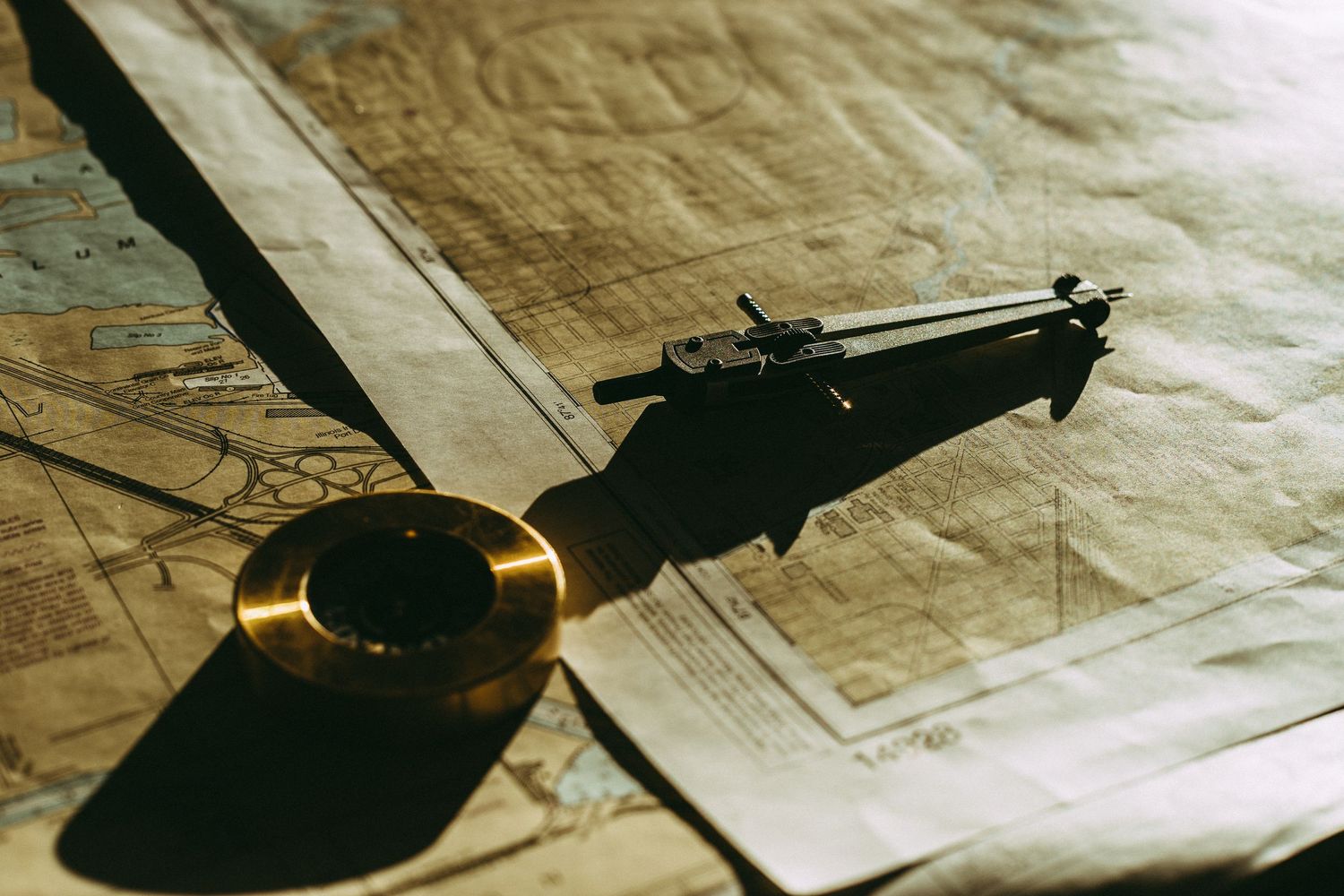 Antique documents and papers with dramatic lighting and shadows.