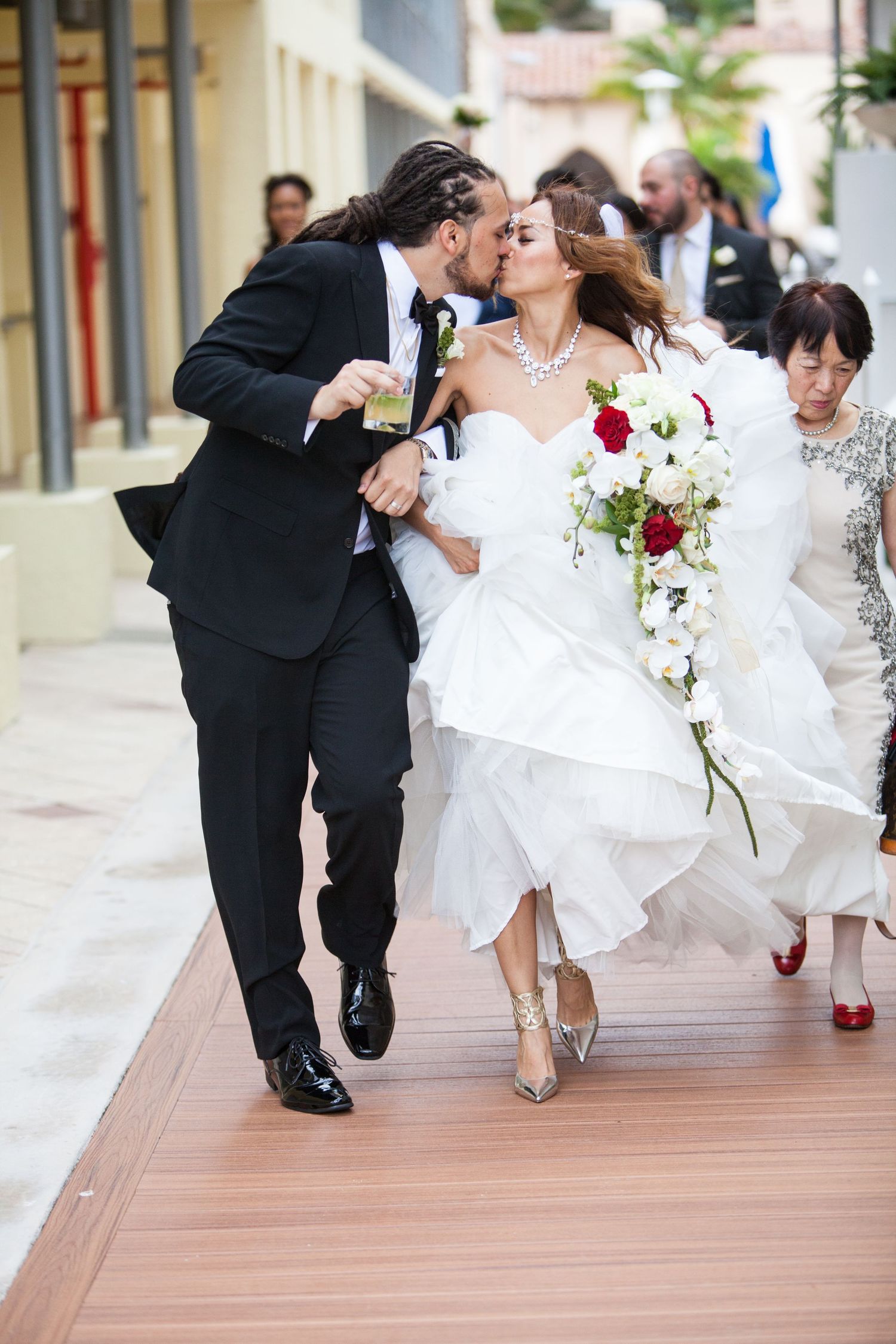 Wedding party feet and shoes captured in motion along a wooden boardwalk.