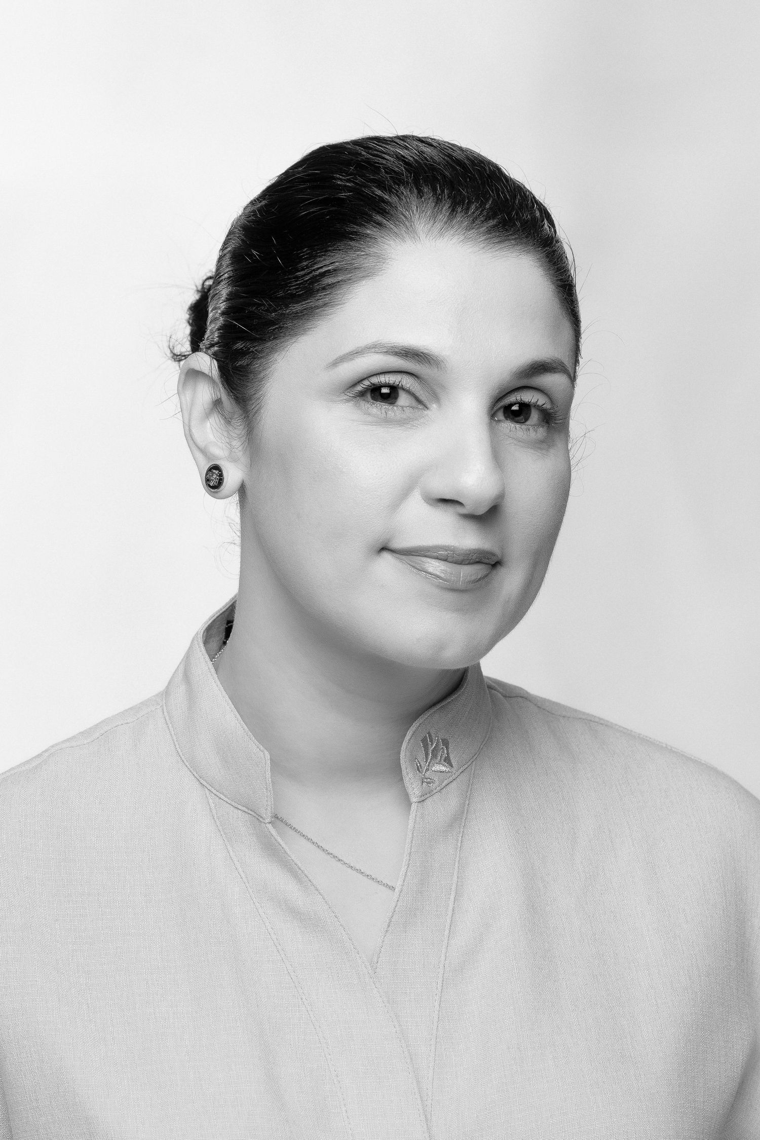 Black and white studio portraits showing progressive expressions from solemn to smiling at the camera.