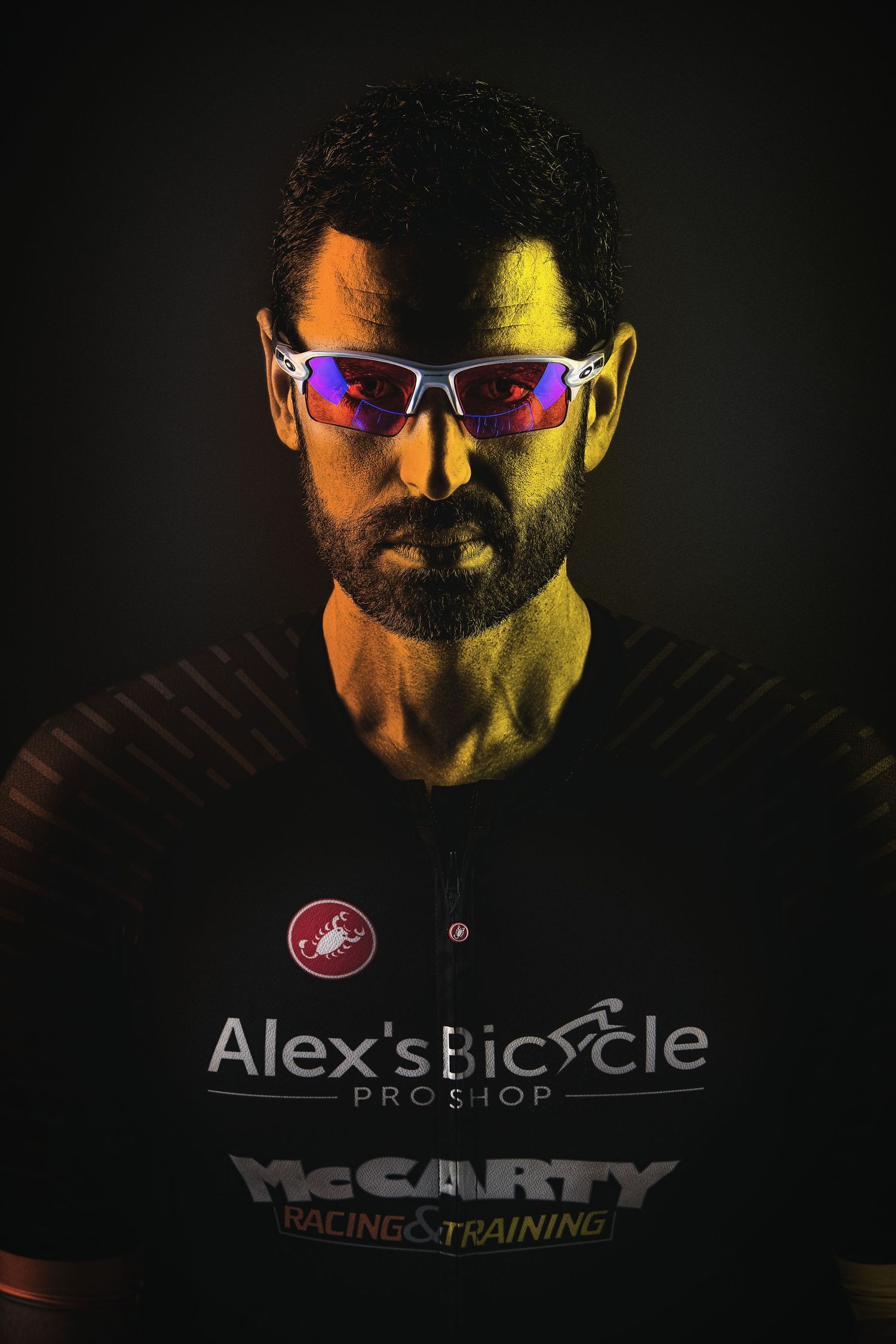 Atmospheric lifestyle photos featuring sports sunglasses and athletic apparel against moody dark lighting.