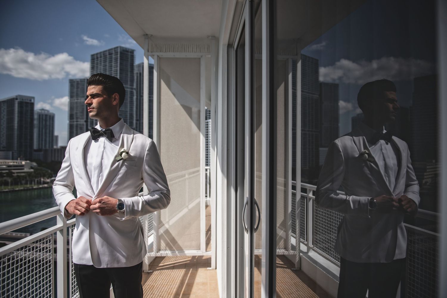 Elegant white formal attire photographed in modern building interior with city views.