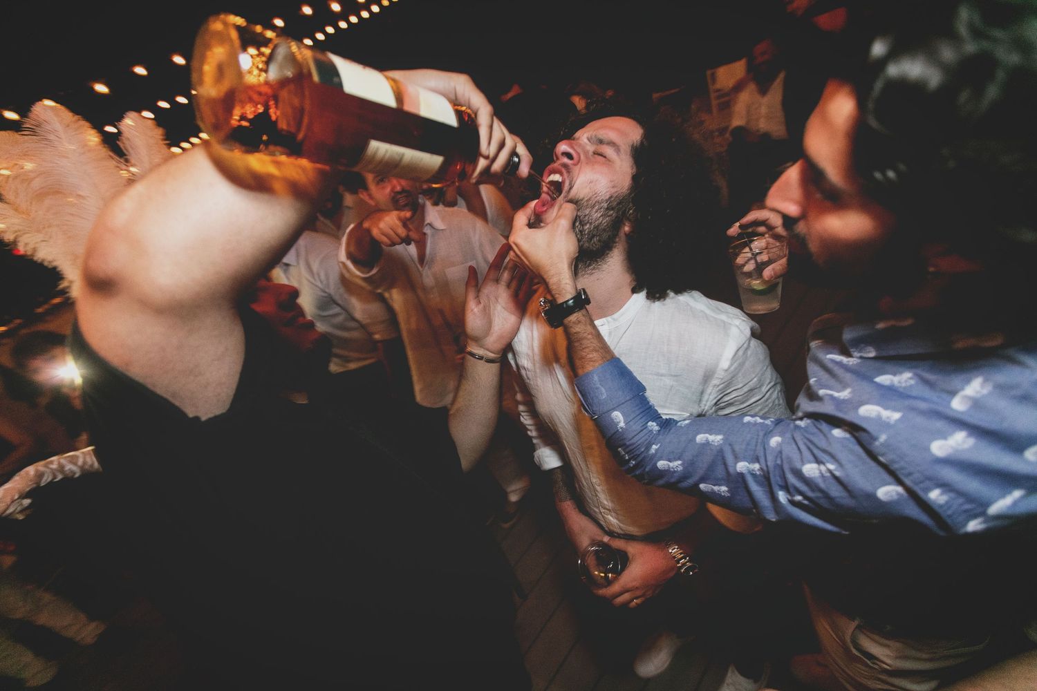 Lively nighttime party scene with dancing and celebration.