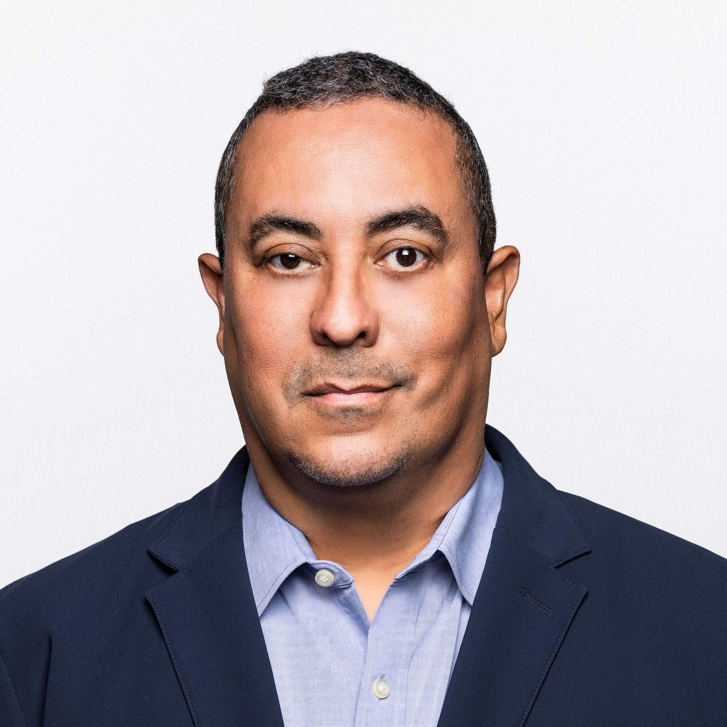 Professional headshot portraits of a man in business attire against a white background showing different facial expressions.