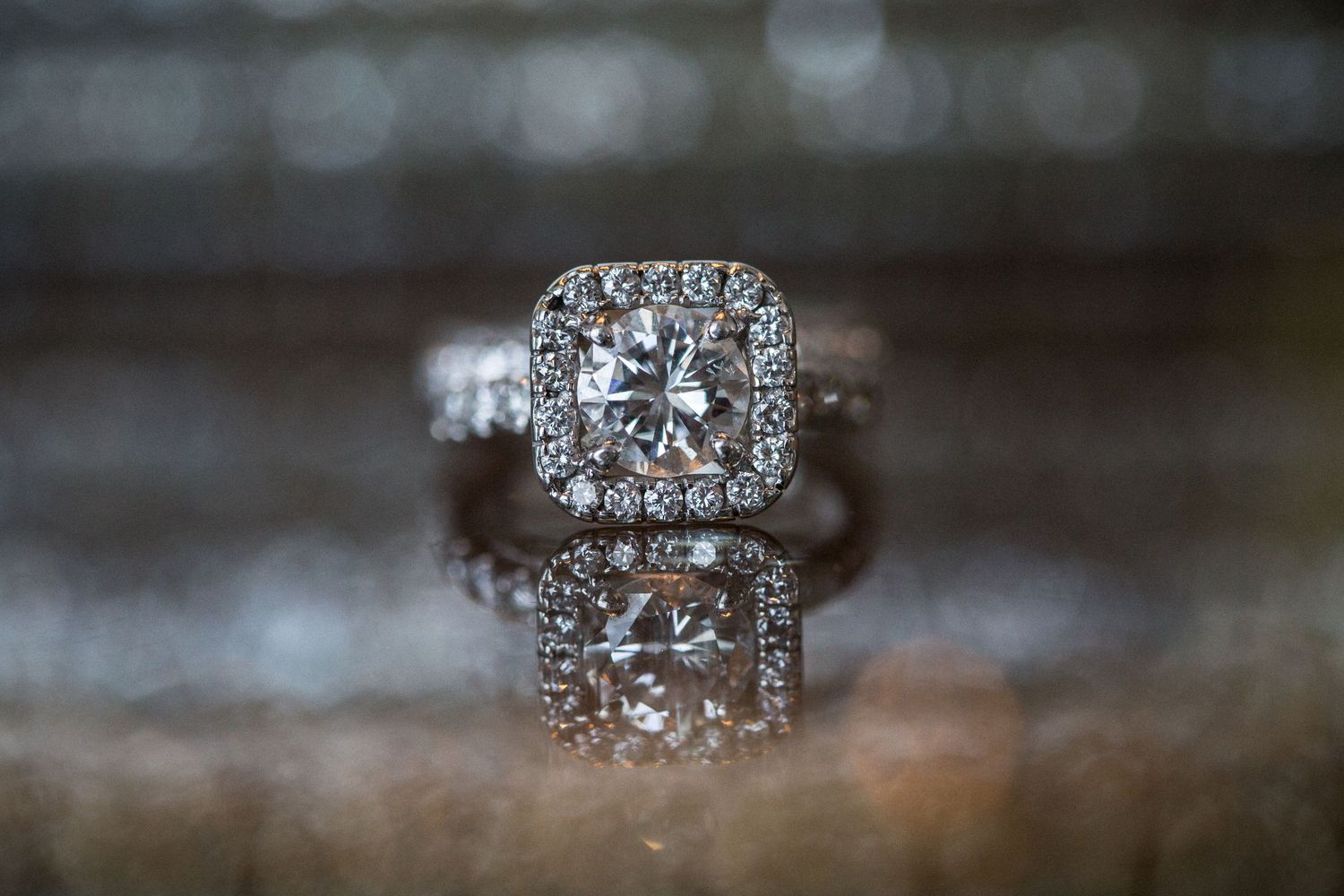 Close-up detail shots of an elegant diamond engagement ring with pave setting in varying angles.