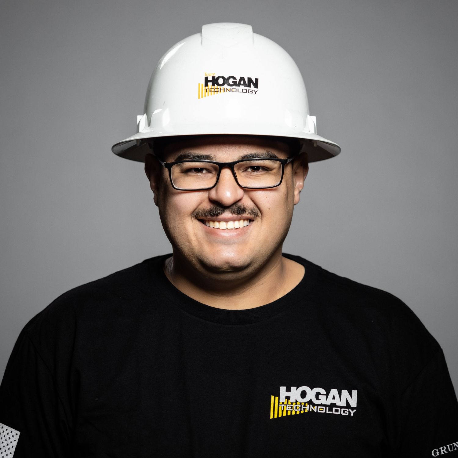 Studio portraits showing different angles of a person wearing a baseball cap against a gray background.