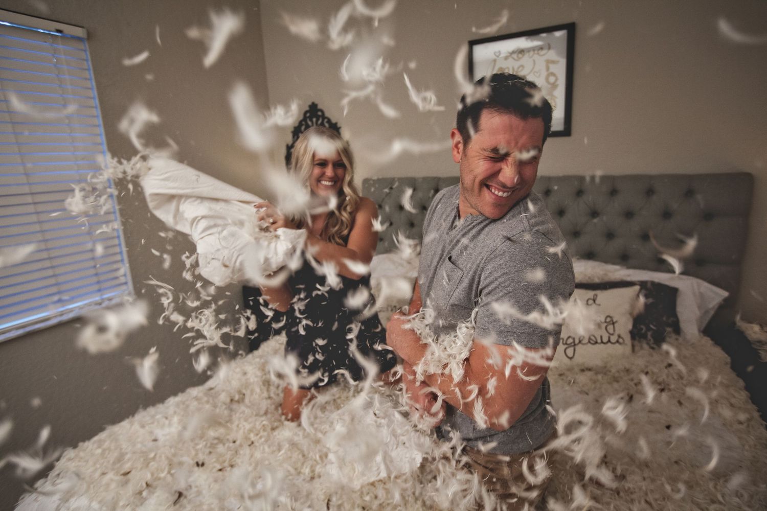 Couple celebrates with confetti and laughter during wedding photoshoot.