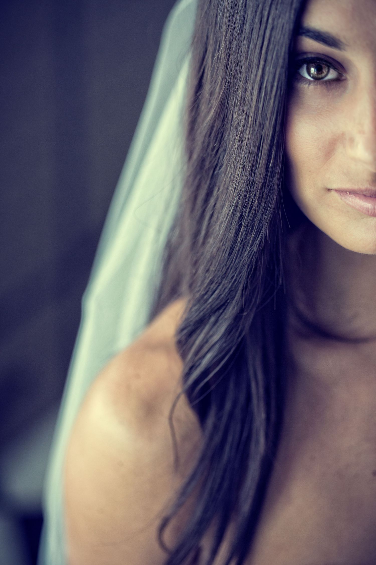 Artistic close-up portrait with dramatic side lighting and shallow depth of field.
