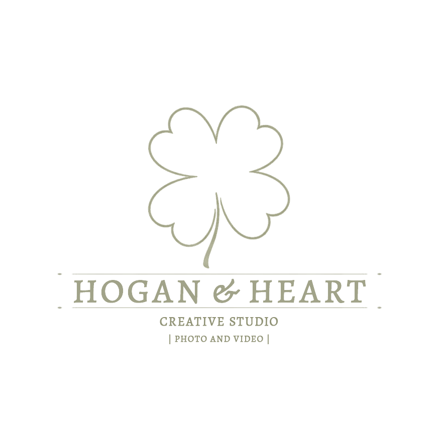 A delicate green clover logo design for Hogan & Heart Creative Studio with text and decorative elements.