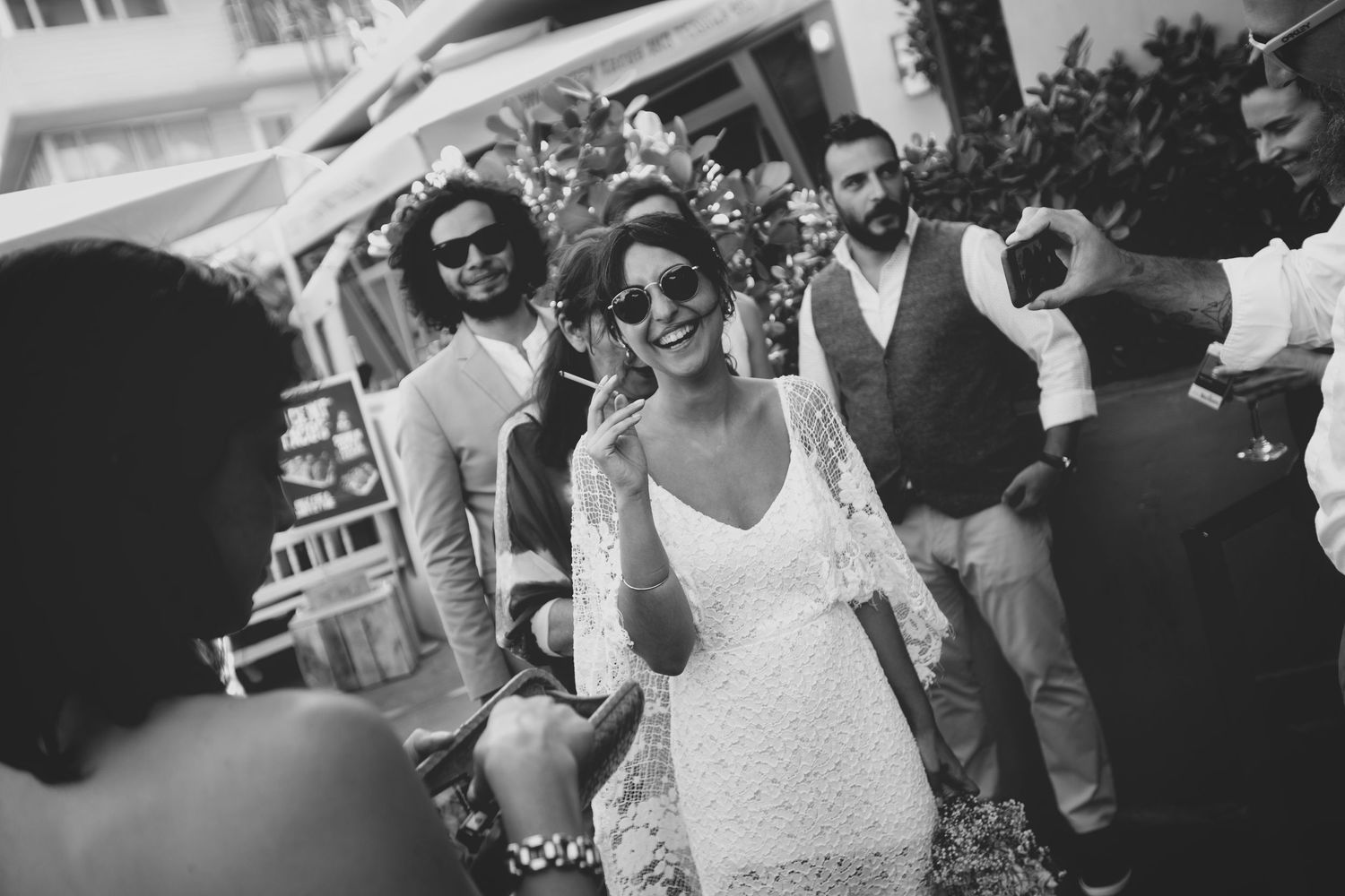 A festive wedding celebration with guests mingling in black and white formal attire.