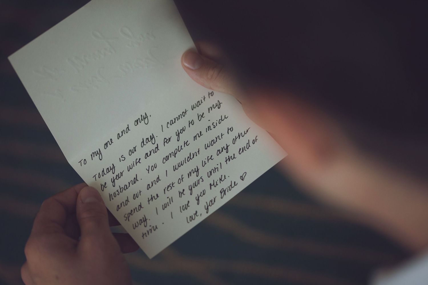 Handwritten note or letter on white paper with blurred edges.
