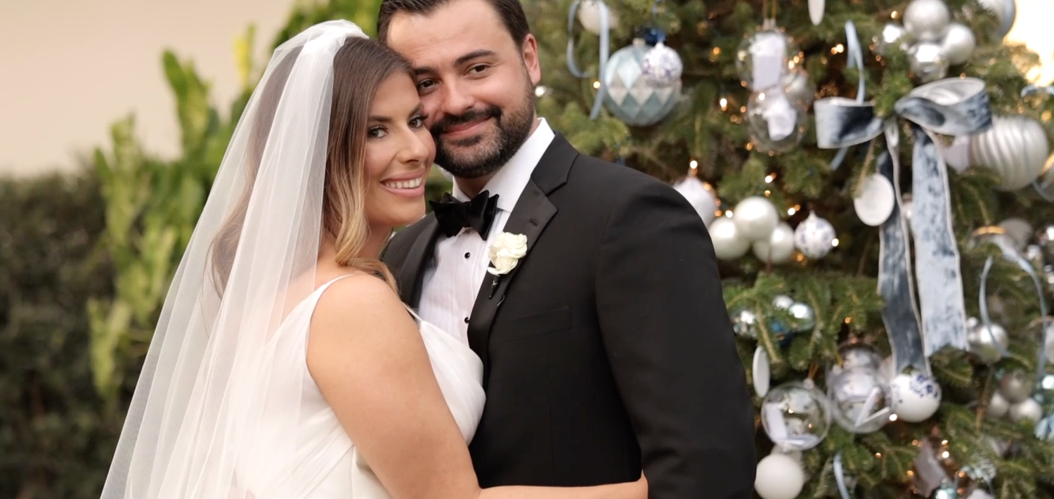 Elegant wedding ceremony decor with white floral arrangements and silver accents.